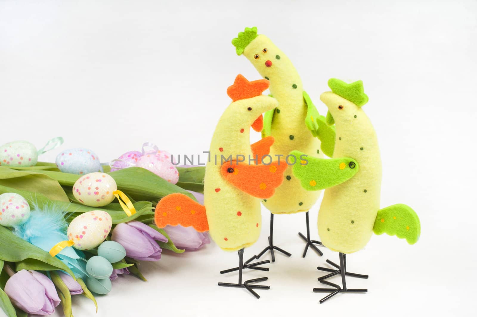 Easter chicken family with tulips and eggs on light background