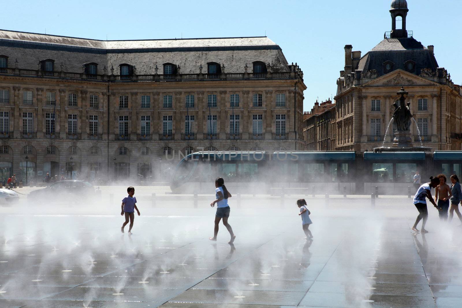 People playing in a city fountain