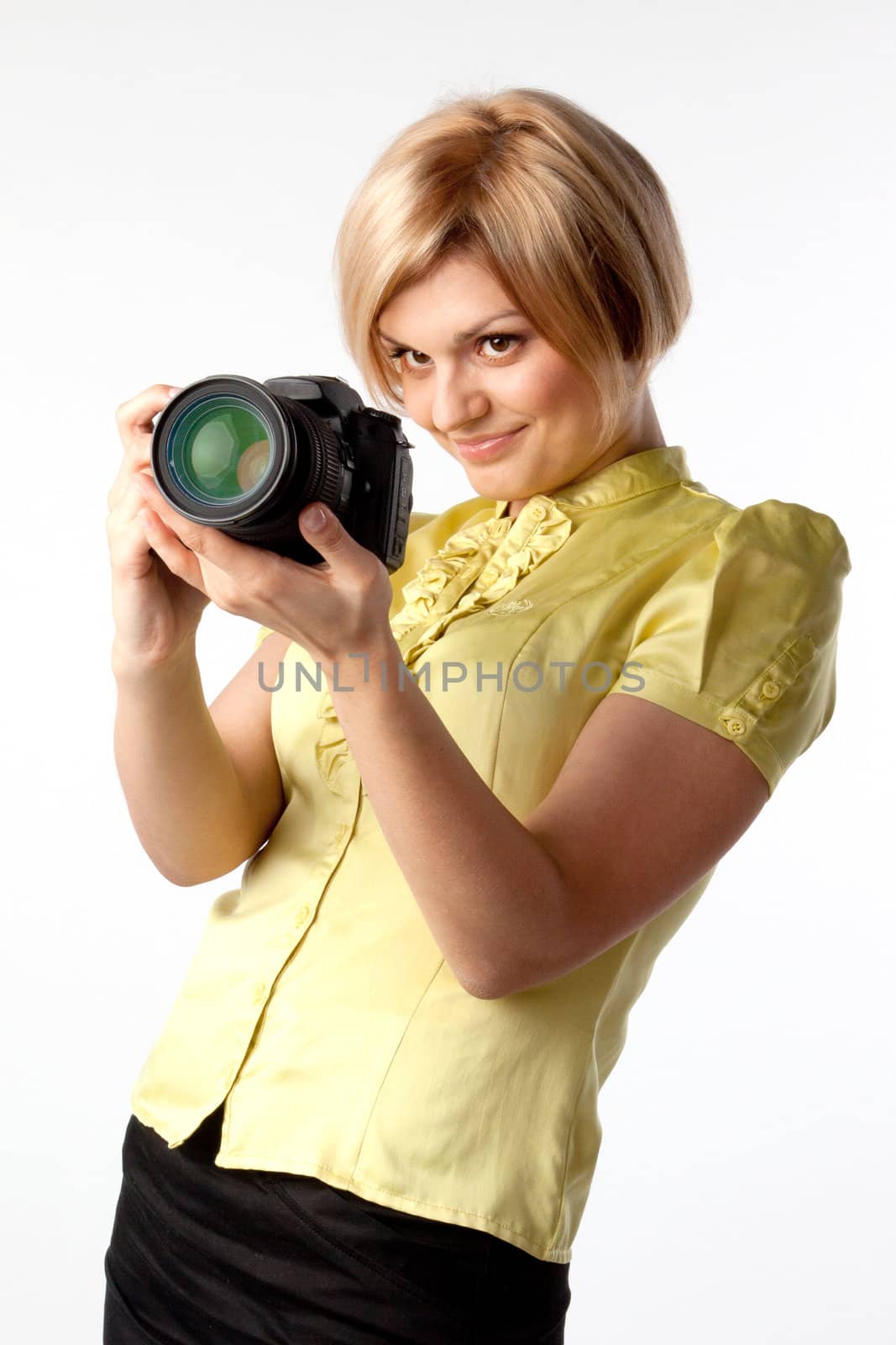 Young and beautiful girl with a professional camera in hand