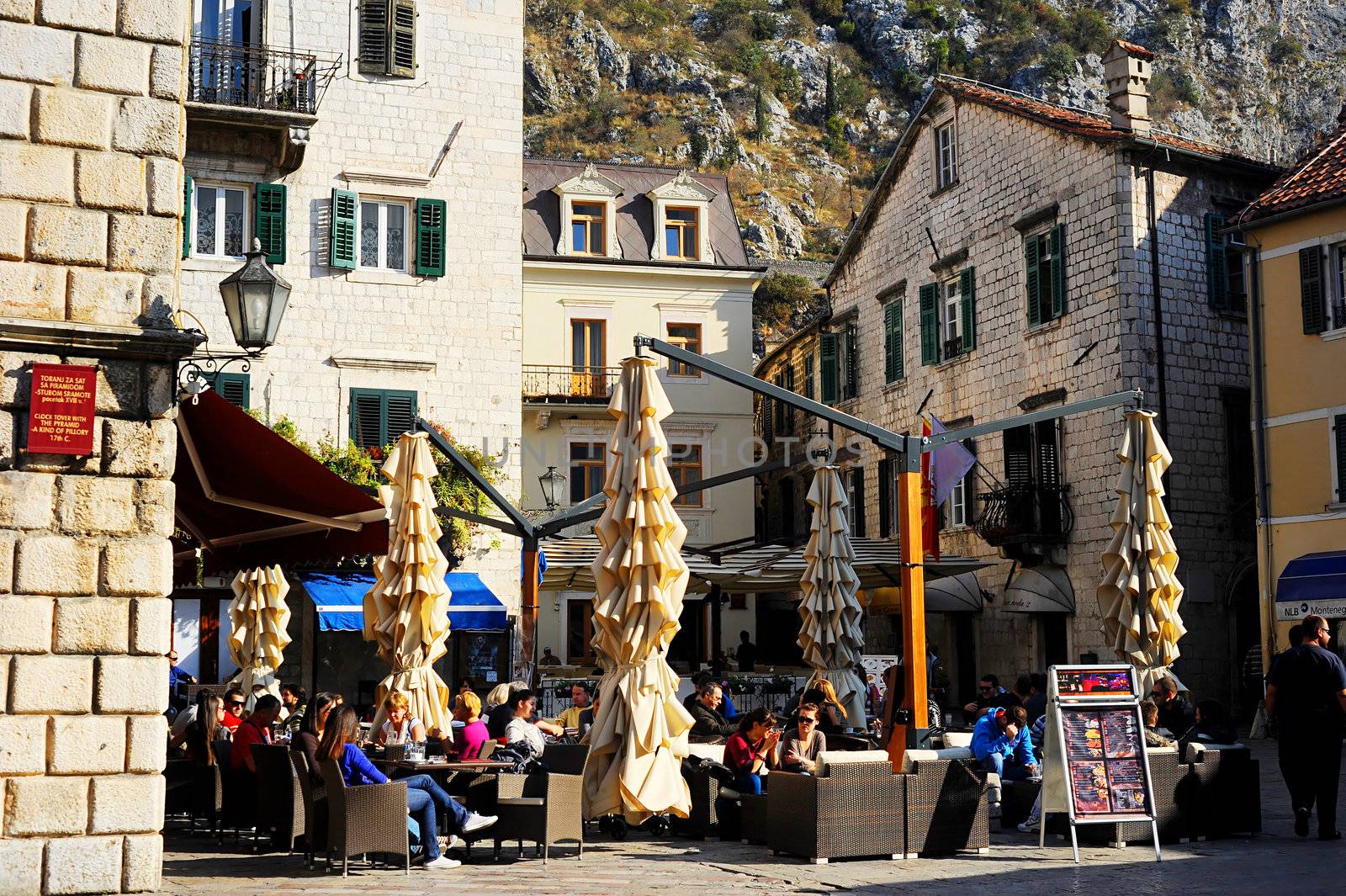 Kotor, Montenegro - November 3, 2011: Street cafe in Kotor old town. Kotor has one of the best preserved medieval old towns in the Adriatic and is a UNESCO world heritage site.