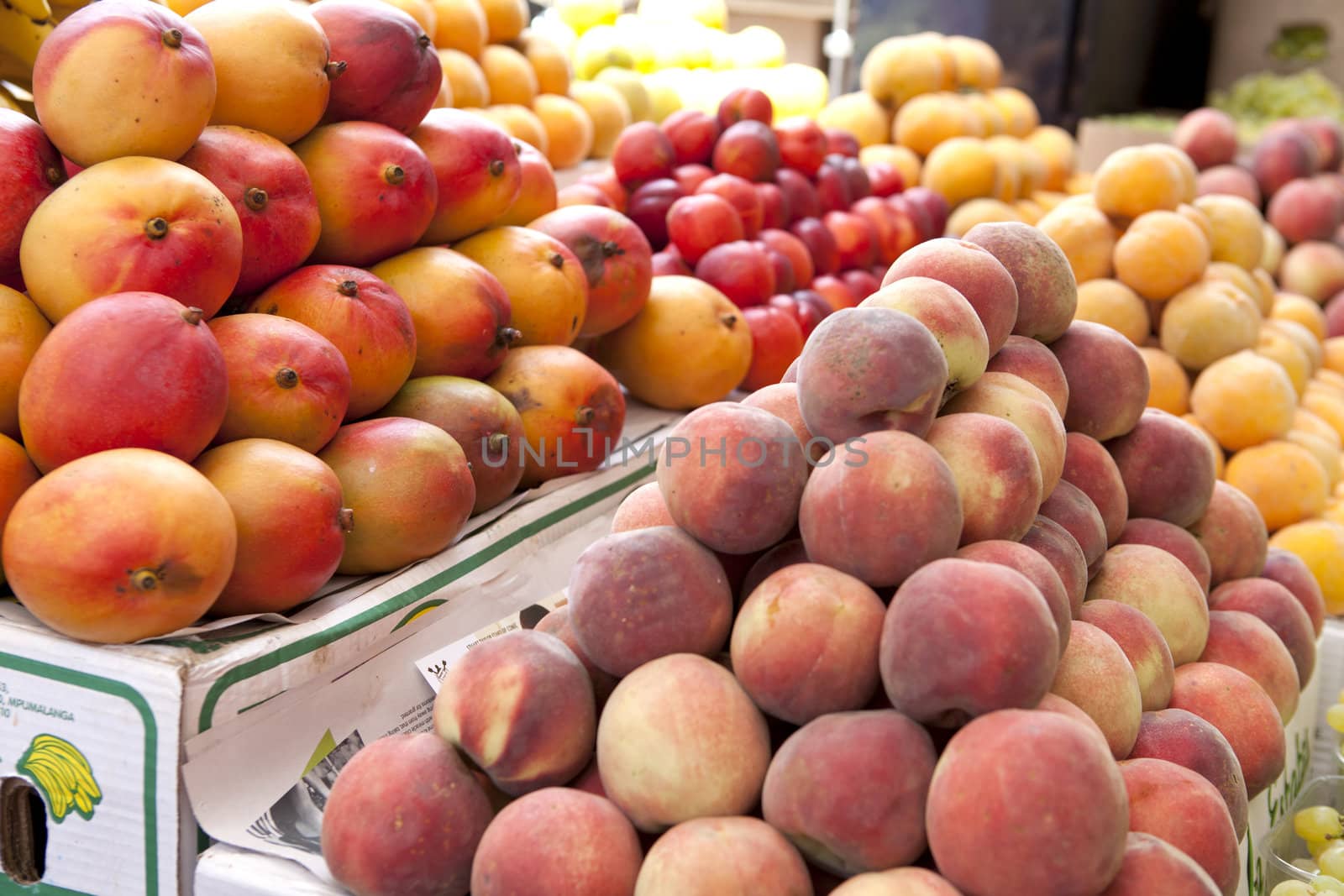 Mango and peaches fruit at the outdoor market in Cape Town.