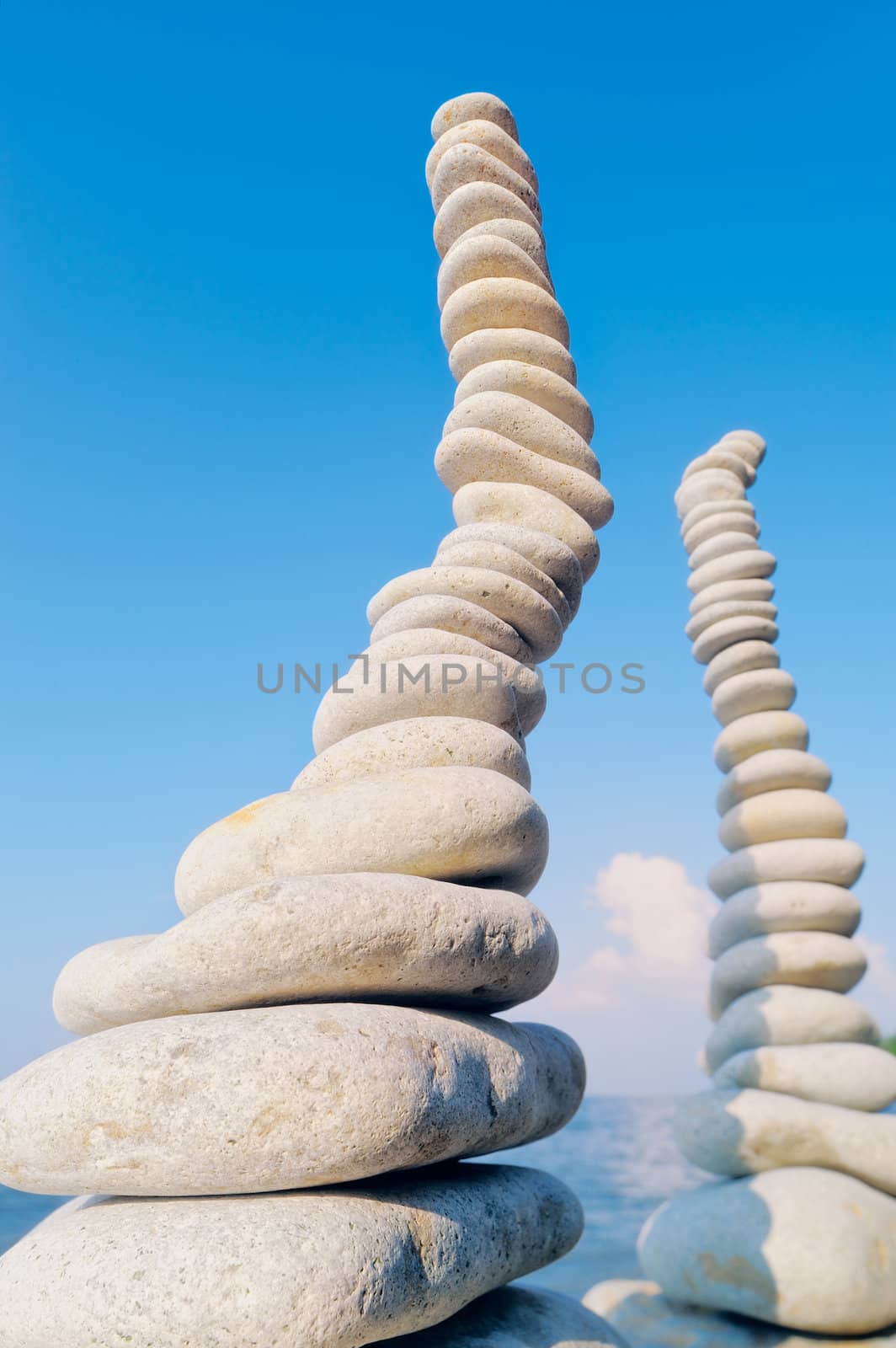 Two pile of pebbles in the balance on the seacoast