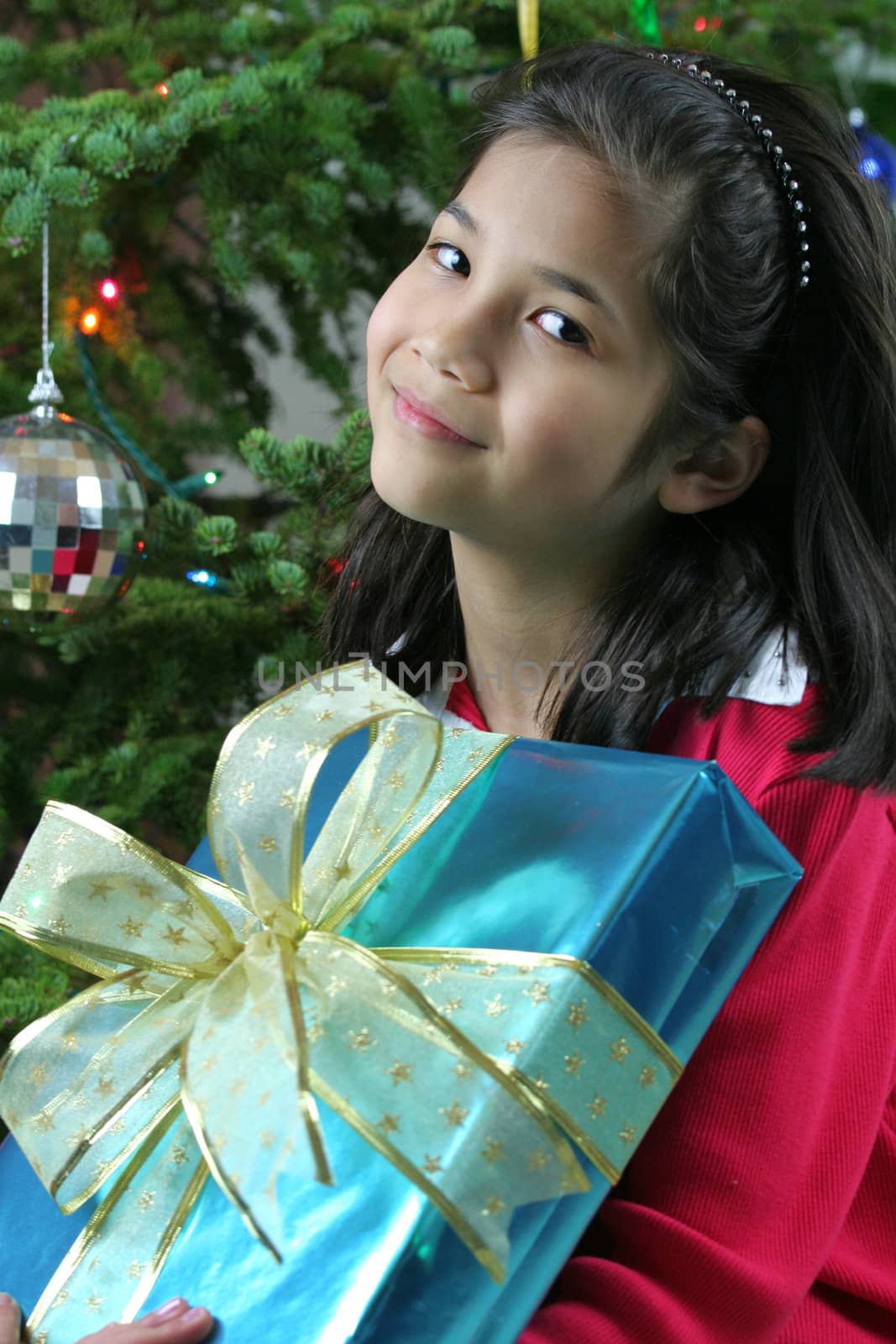 Happy child with Christmas gift by jarenwicklund