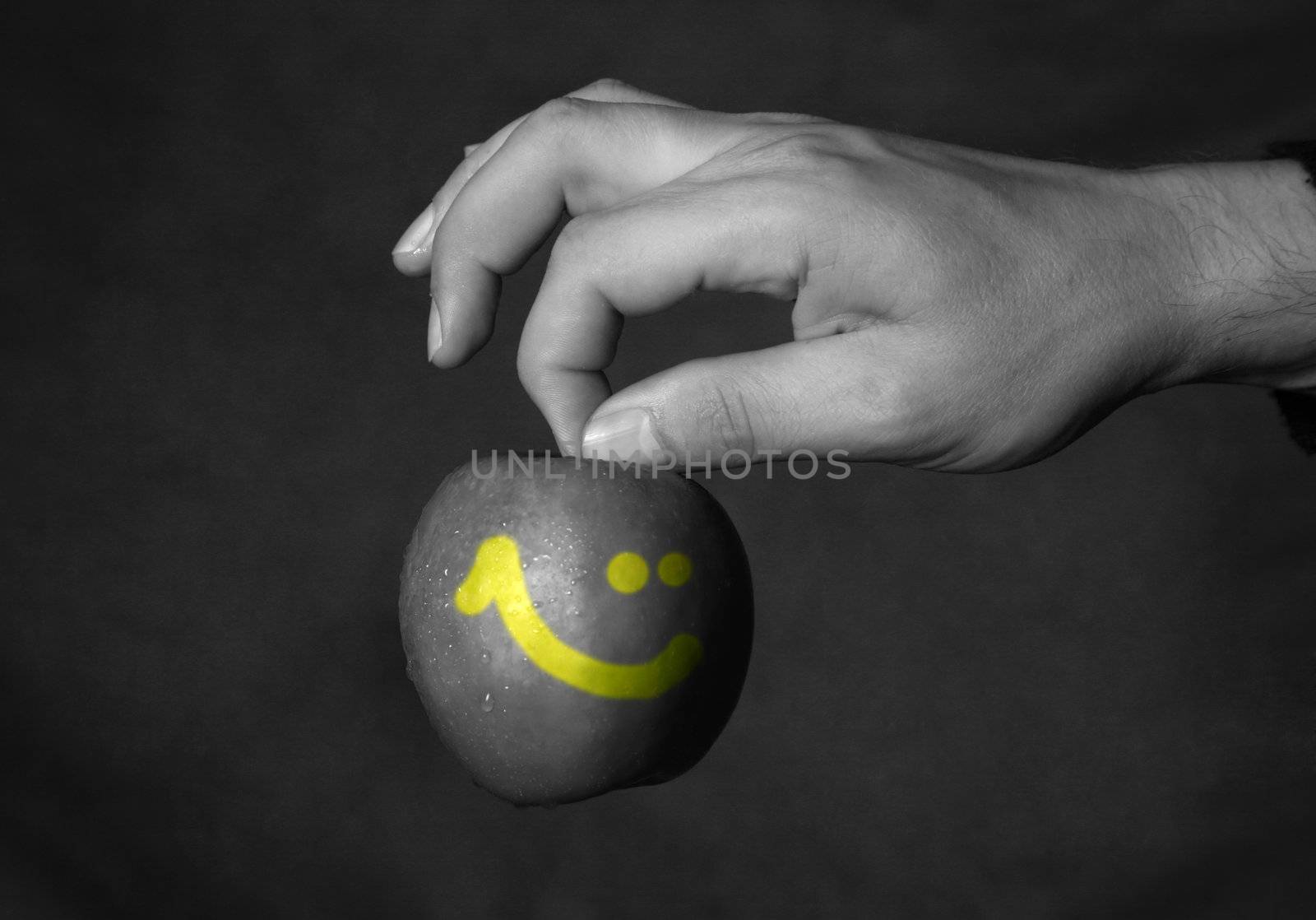 Man's hand with a apple on a dark background