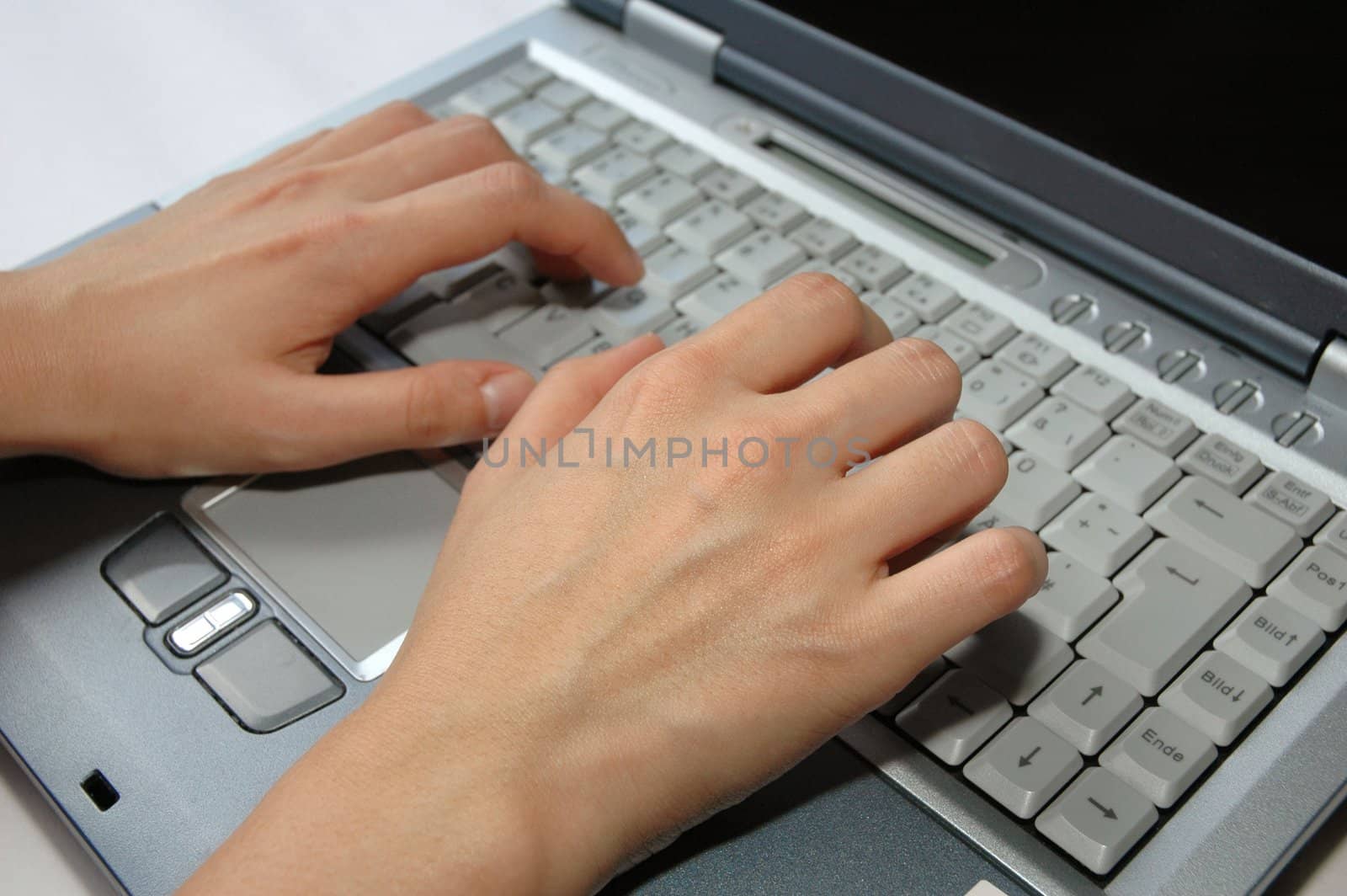Fingers typing laptop / keyboard / notebook