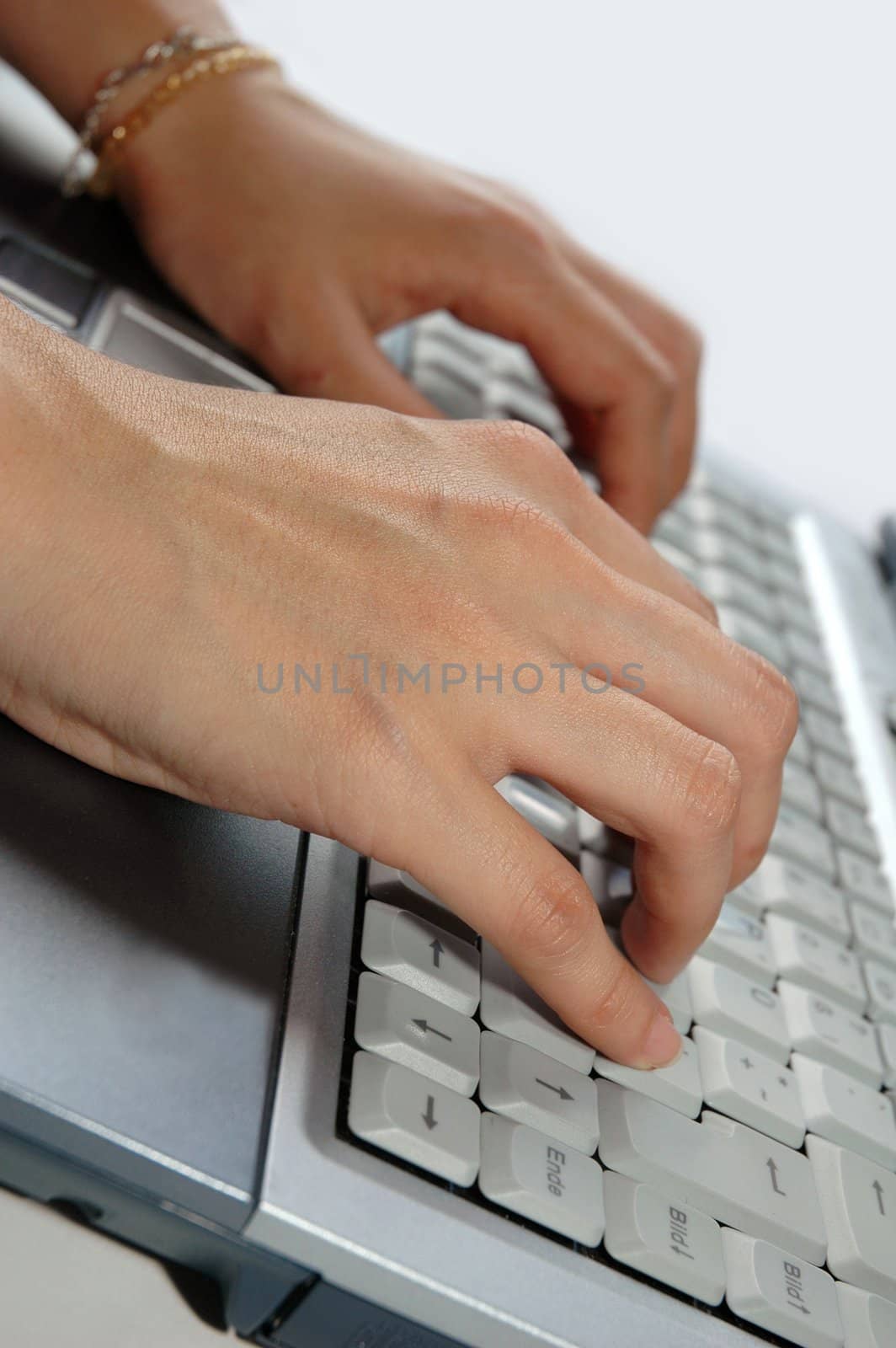 Fingers typing laptop / keyboard / notebook