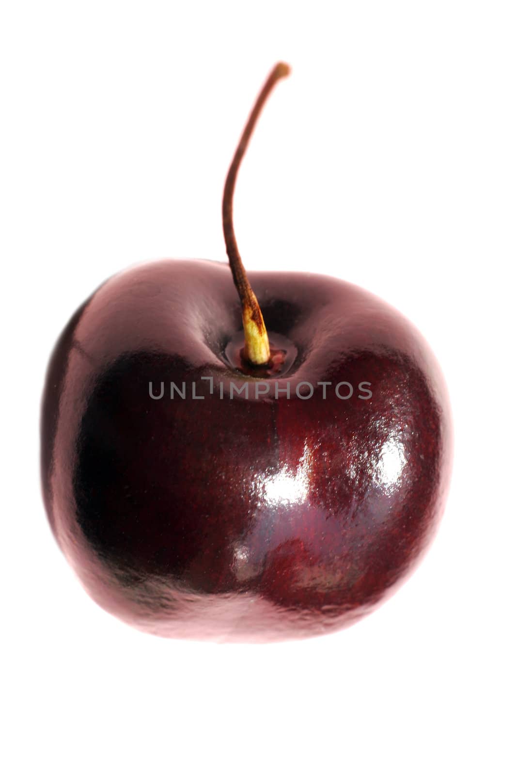 The image of a sweet cherry with a drop on a white background