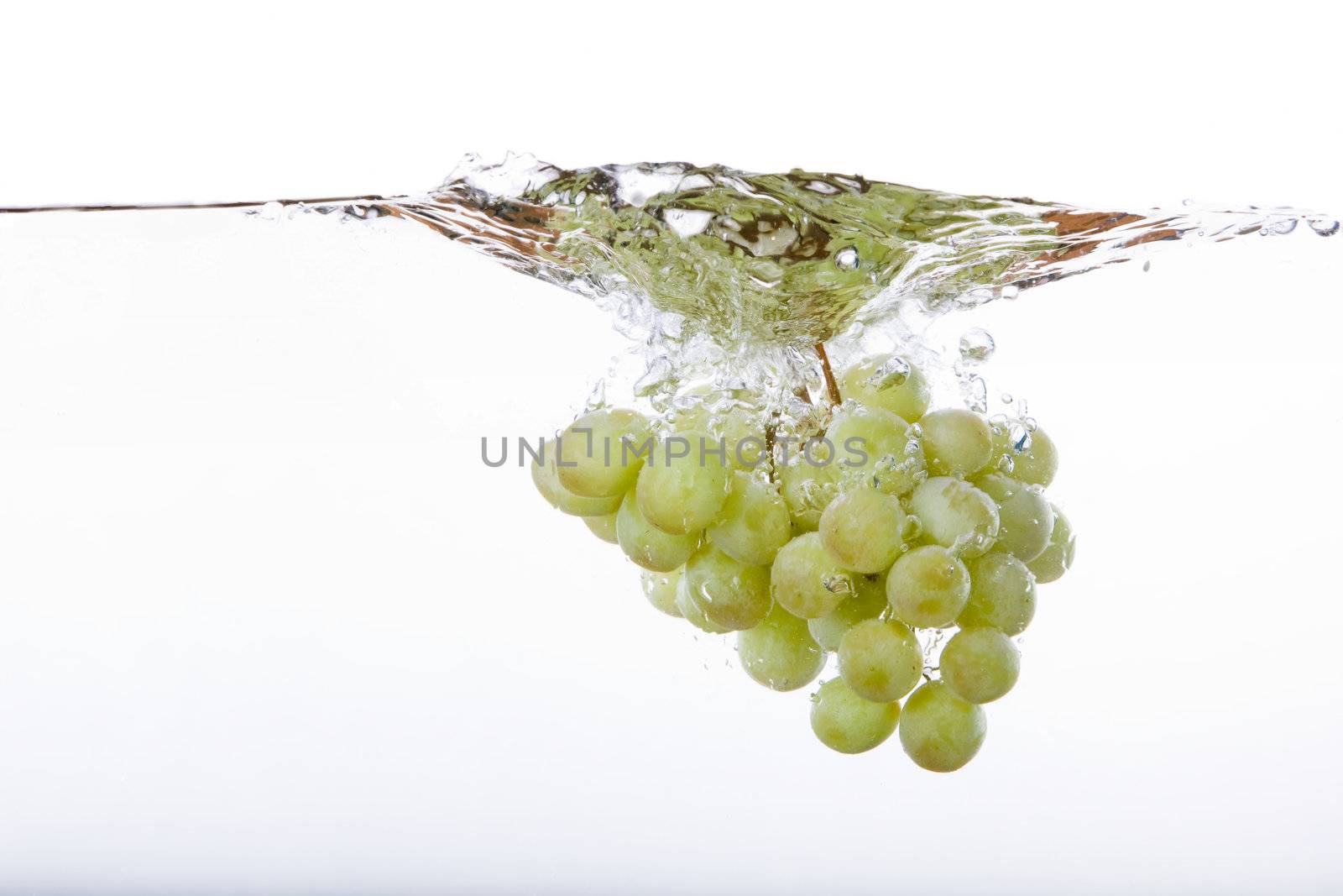 Grapes on the vine in water with splash