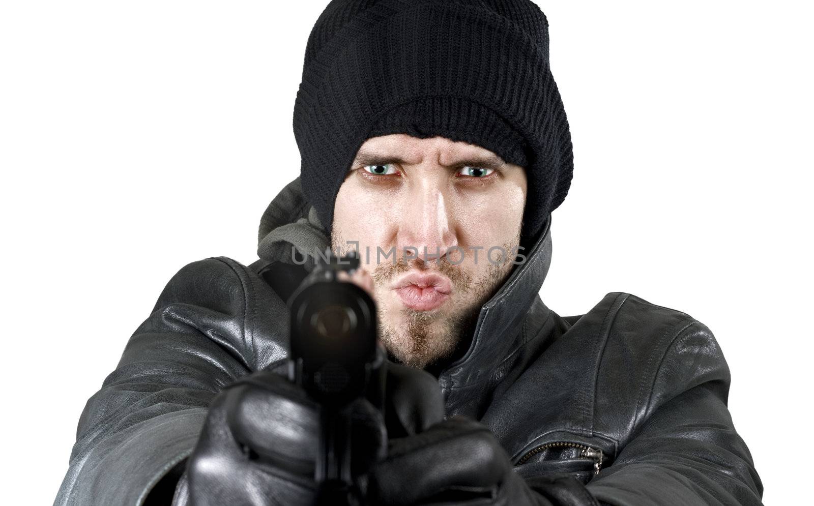 Portrait of an undercover agent or delinquent dressed in black leather and balaclava hat firing handgun in the camera.

Studio shot.