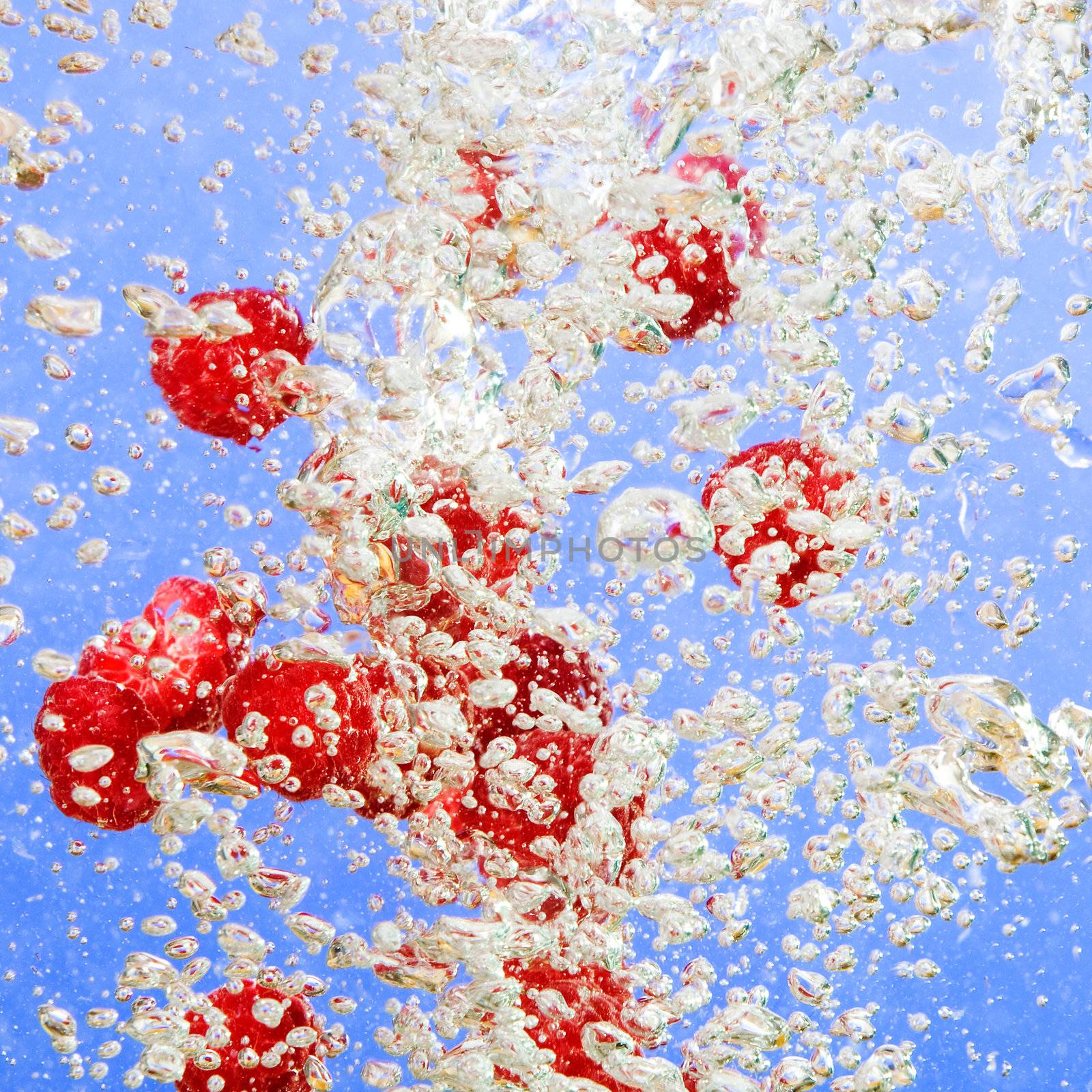 Raspberry and bubble background over blue.