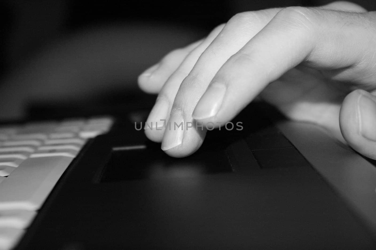 Fingers touching a notebook touchpad