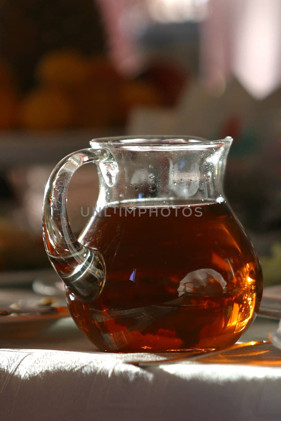 Jug with juice covered by the sun