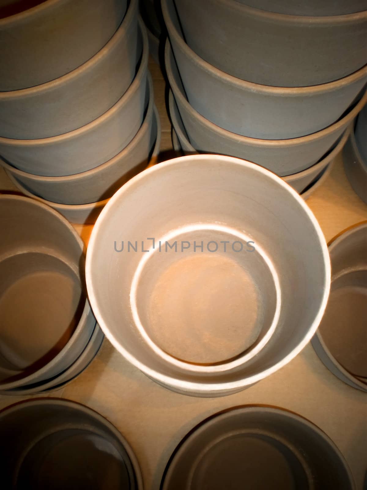 Clay pots stacked up irregularly, with the centre pot standing out from the rest.