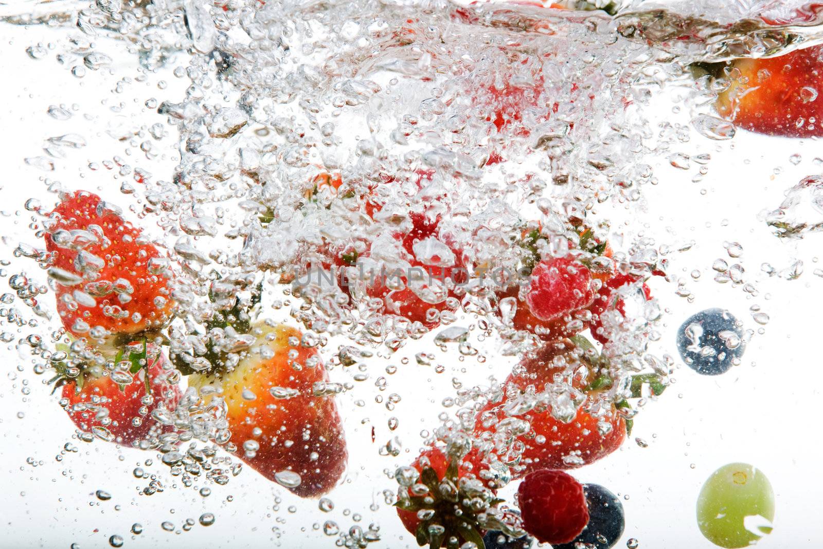 Fresh fruit background in water over white
