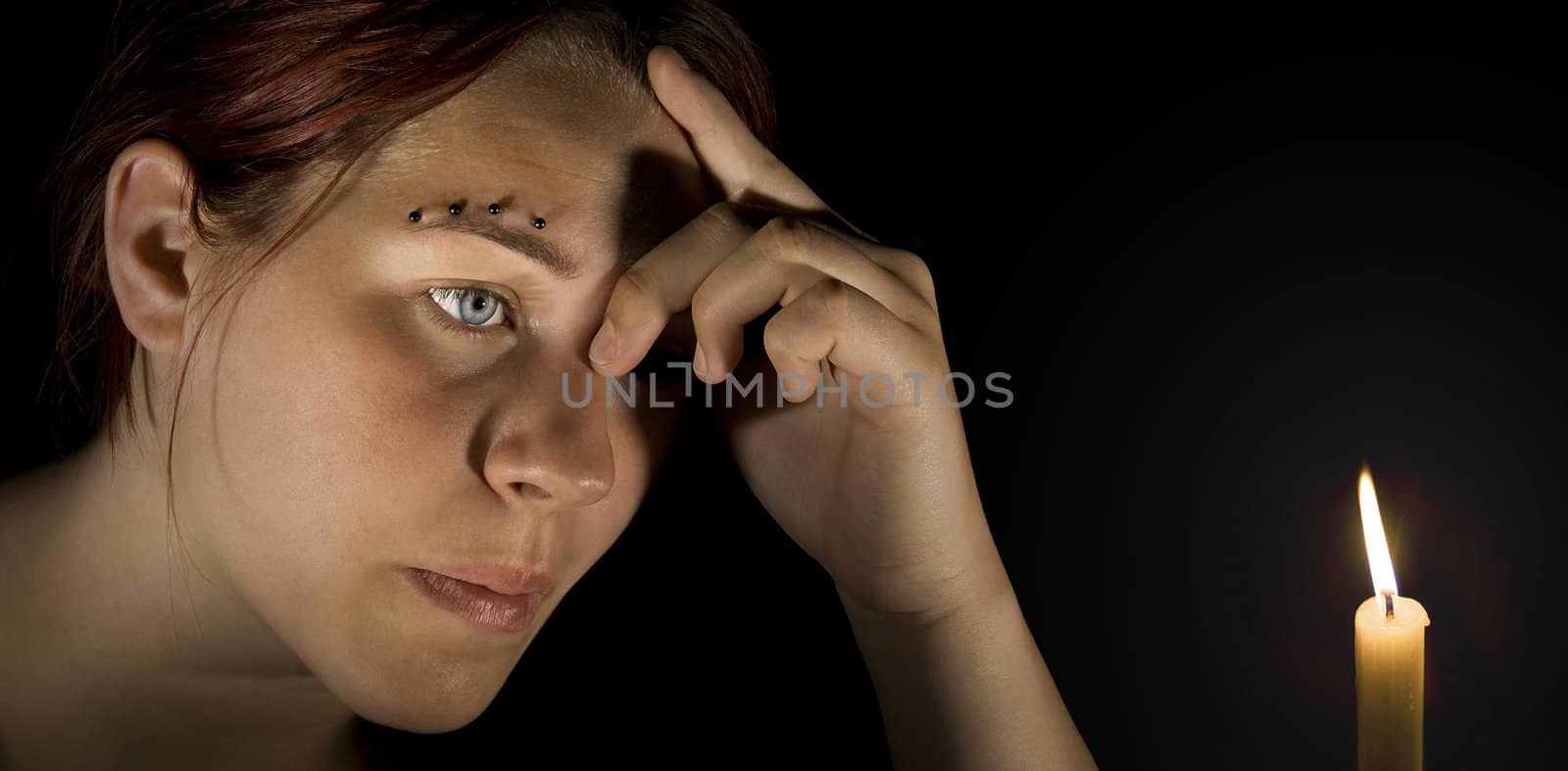 Pensive girl holding her head. Lit with two off-camera goboed flashes.