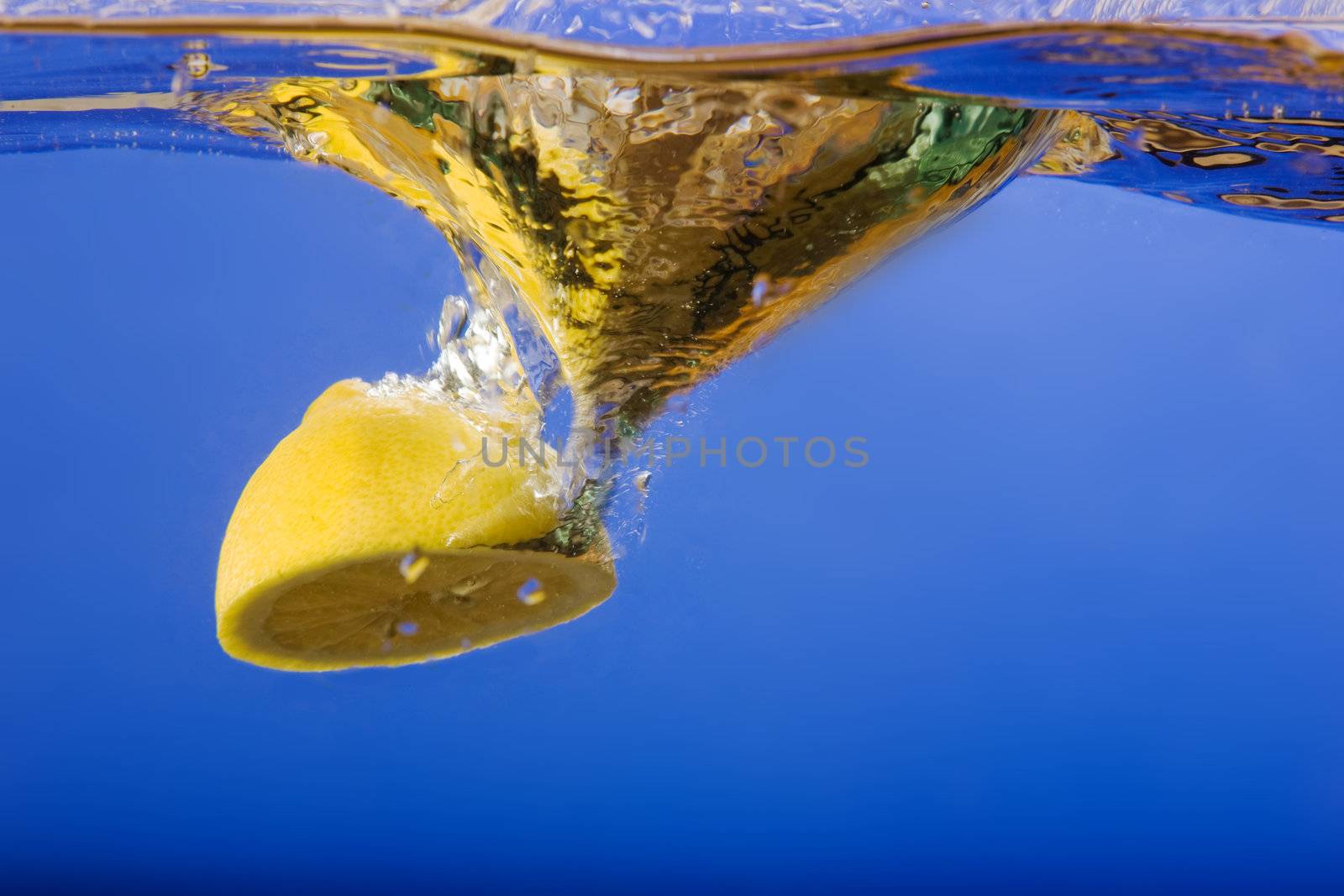 A lemon with a blue background in water