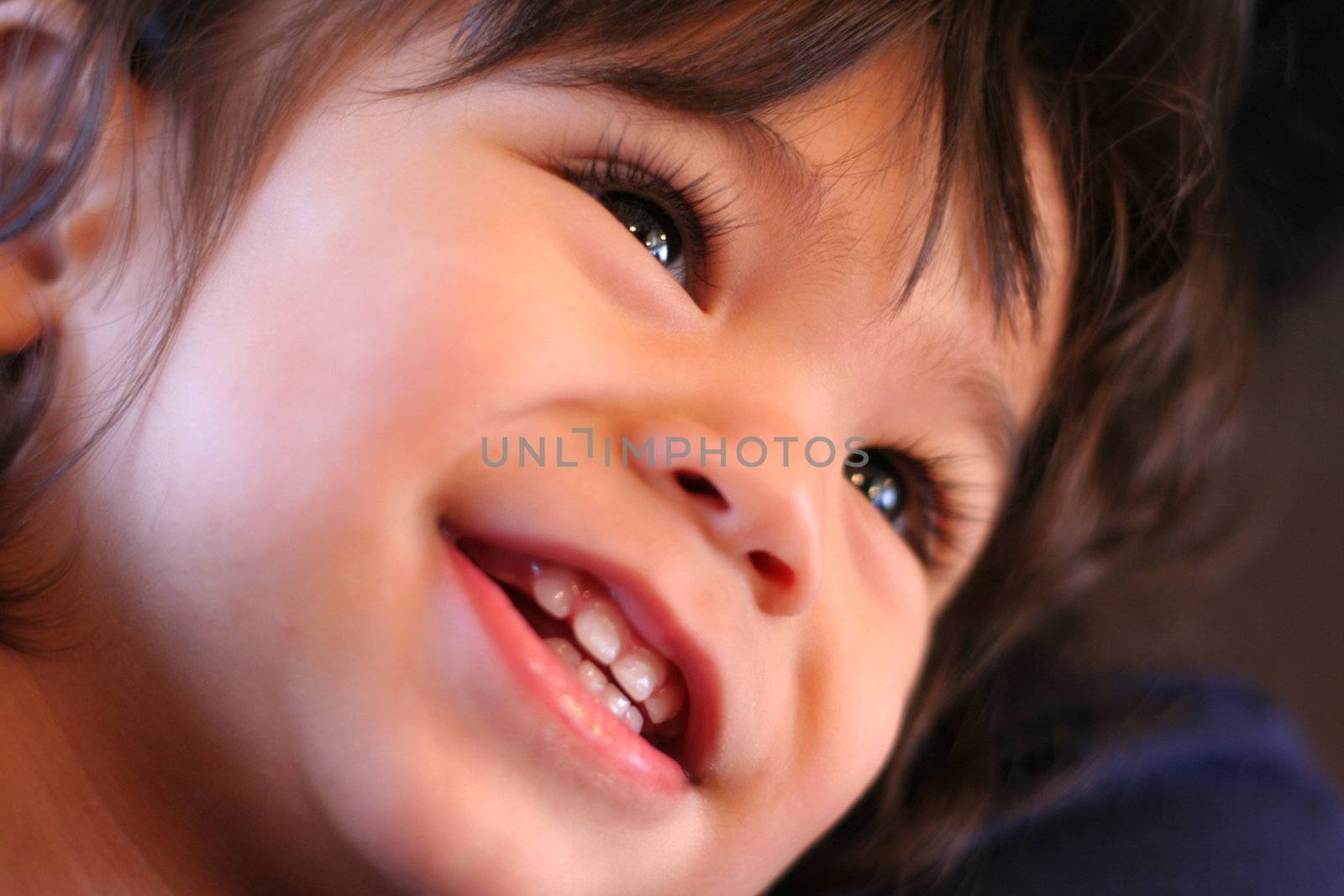 Adorable toddler smiling and looking upwards. Part asian, scandinavian background.