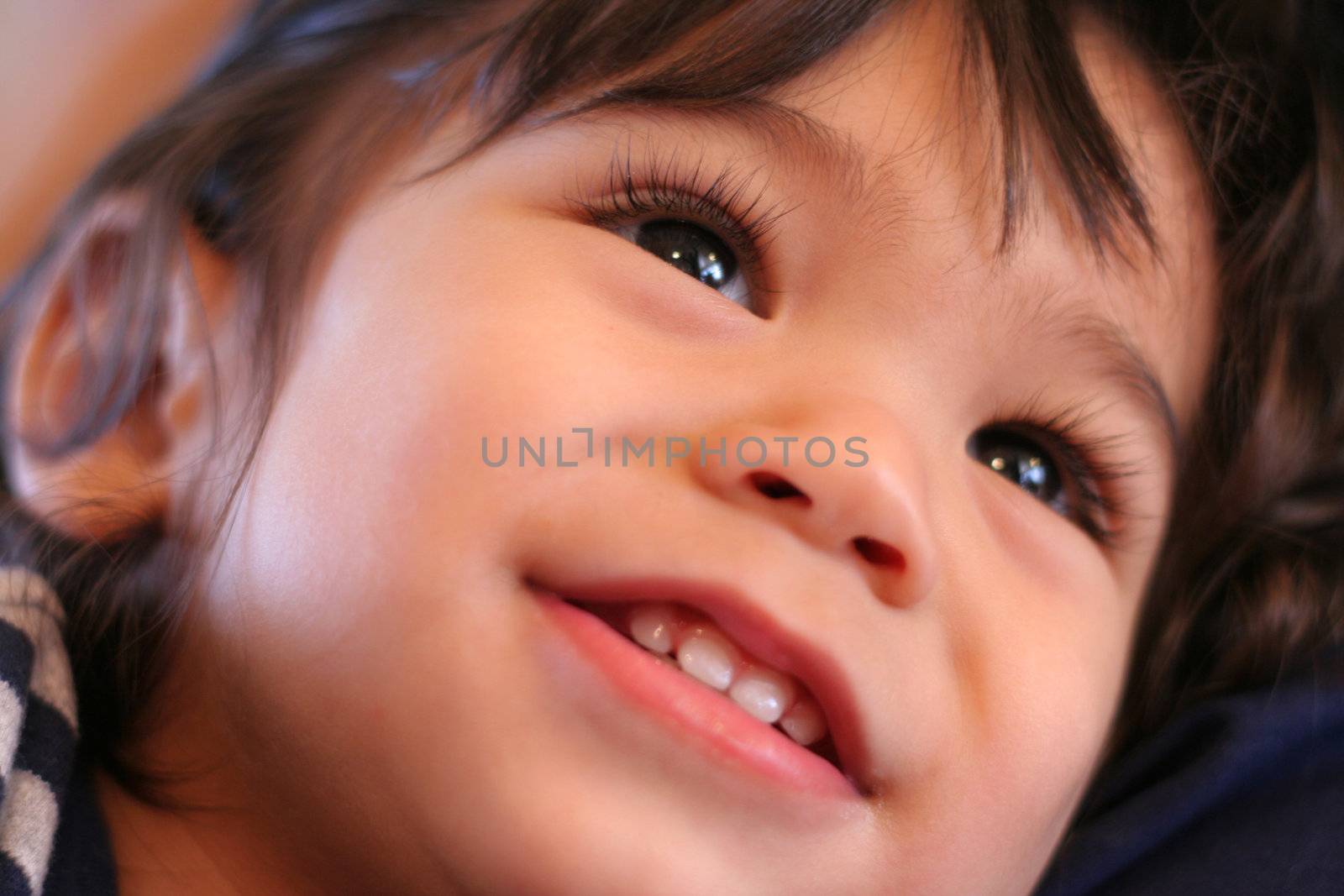 Adorable toddler smiling and looking upwards. Part asian, scandinavian background.