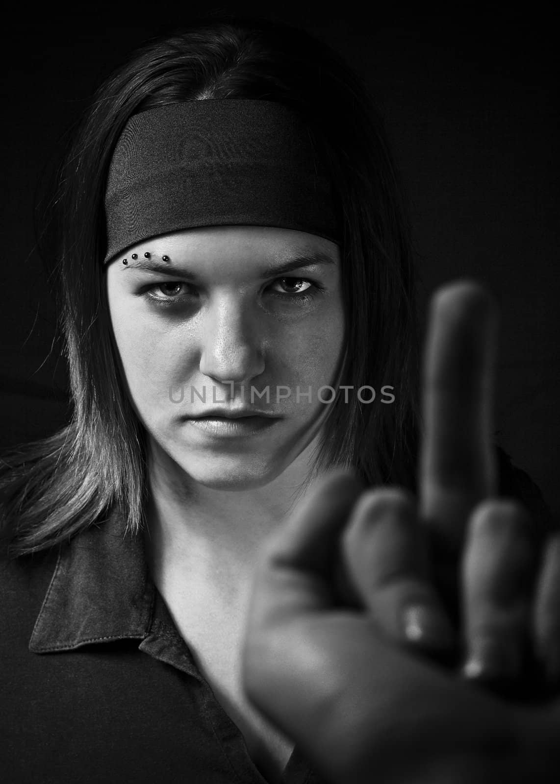 Girl ignoring a middle finger gesture and aggresively staring back (in black and white).