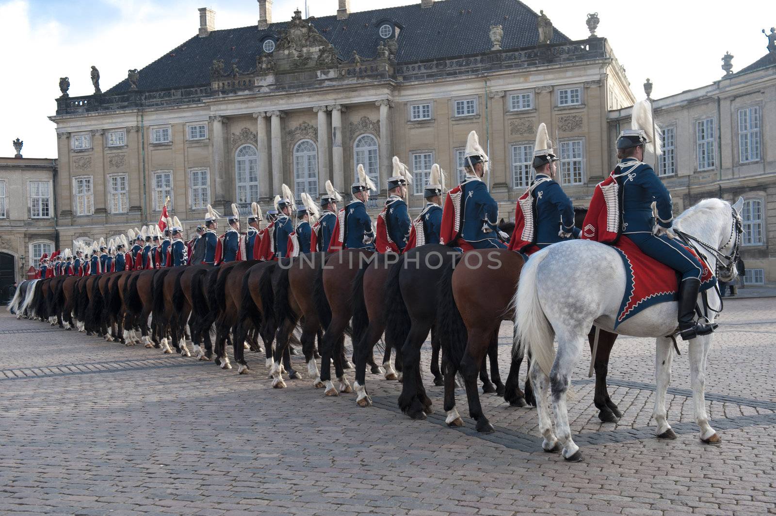 The Royal Danish Guard patrols the royal residence Amalienborg Palace and serves the royal Danish family.  Amalienborg is also known for the Danish Royal Guard, who patrol the palace grounds. The Danish Royal Guard march from Rosenborg Castle at 11.30am daily through the streets of Copenhagen, and execute the changing of the guard in front of Amalienborg Palace at noon. When the Queen is in residence the guard is accompanied by the Royal Guards music band. 