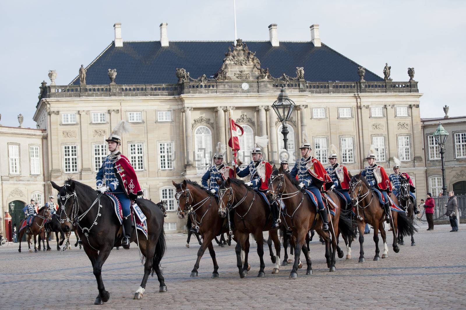 The Royal Danish Guard patrols the royal residence Amalienborg Palace and serves the royal Danish family.  Amalienborg is also known for the Danish Royal Guard, who patrol the palace grounds. The Danish Royal Guard march from Rosenborg Castle at 11.30am daily through the streets of Copenhagen, and execute the changing of the guard in front of Amalienborg Palace at noon. When the Queen is in residence the guard is accompanied by the Royal Guards music band. 