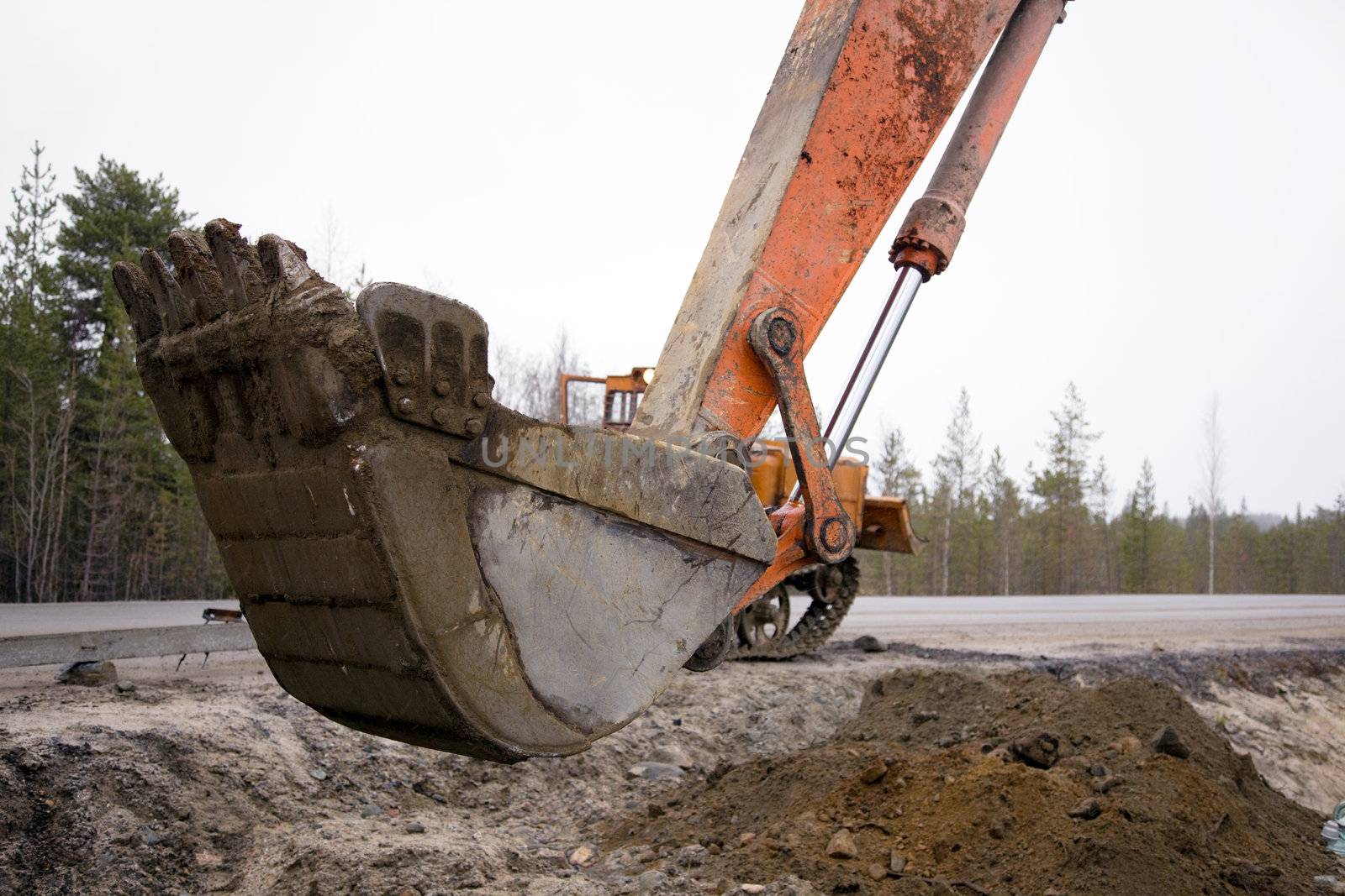 Bucket excavator digging on road works