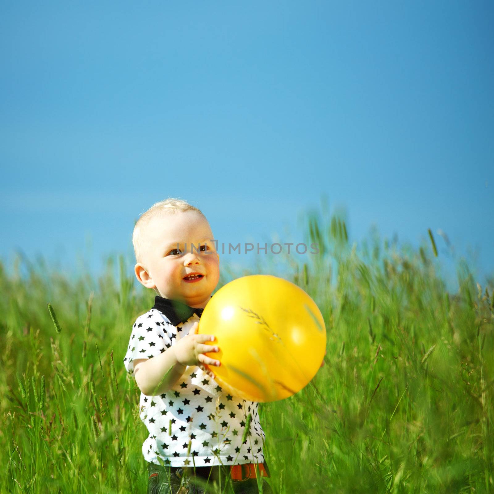 young smile boy play yellow ball