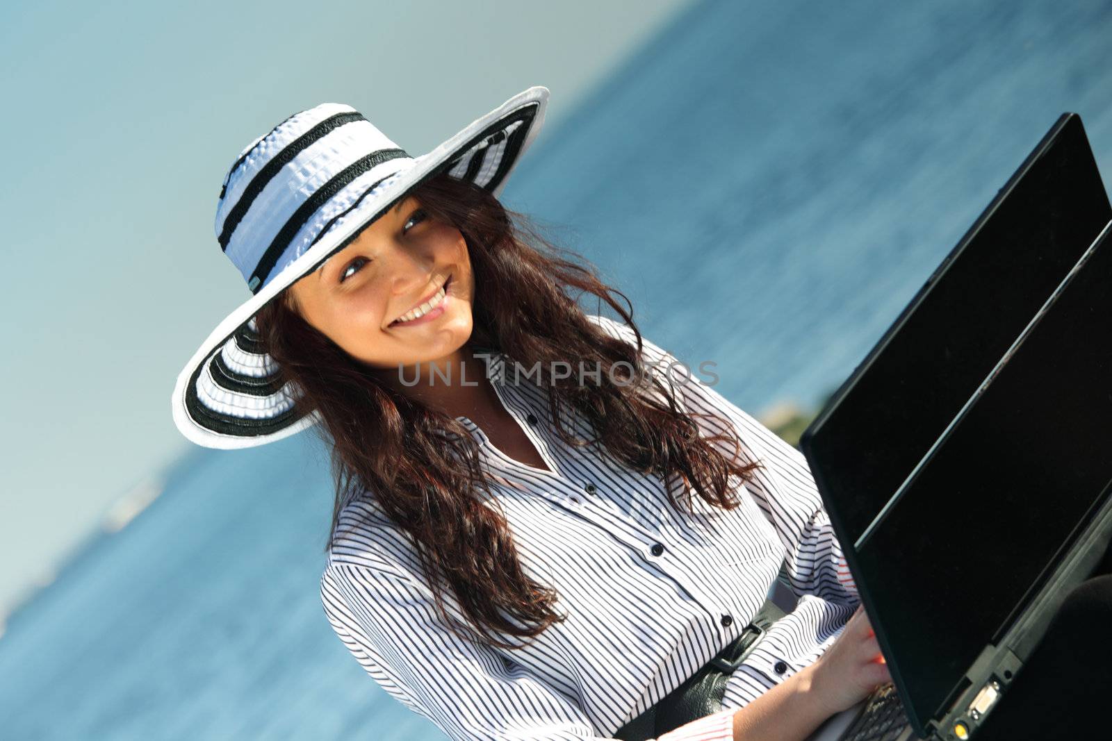 woman work on laptop sea on background