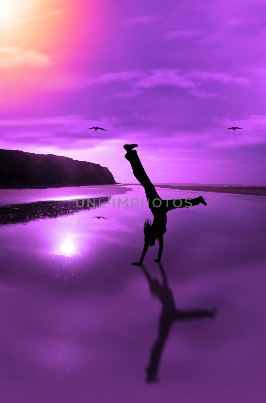 a happy young woman celebrating on an isolated irish beach in motion