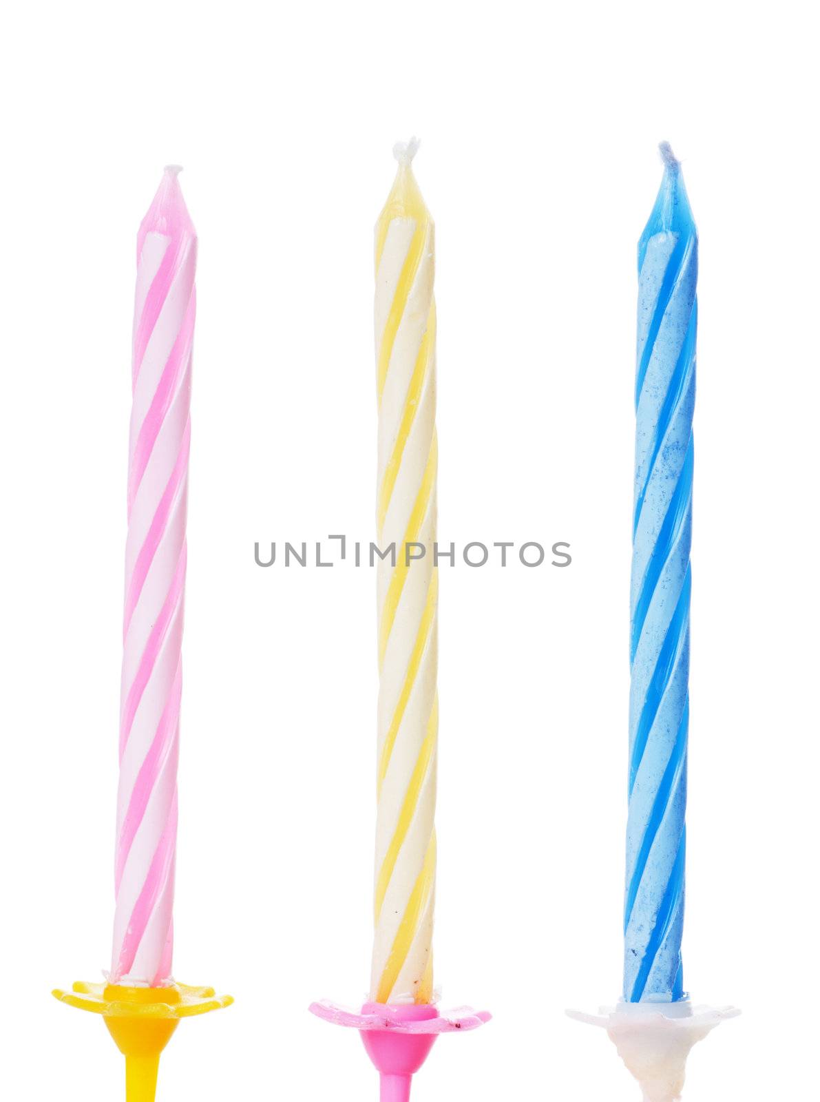 Closeup view of three colorful birthdays candle