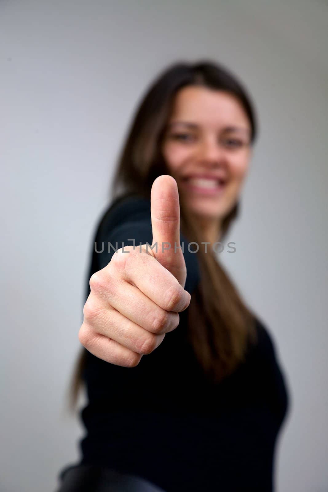 close up of young woman with thumb up smiling happy