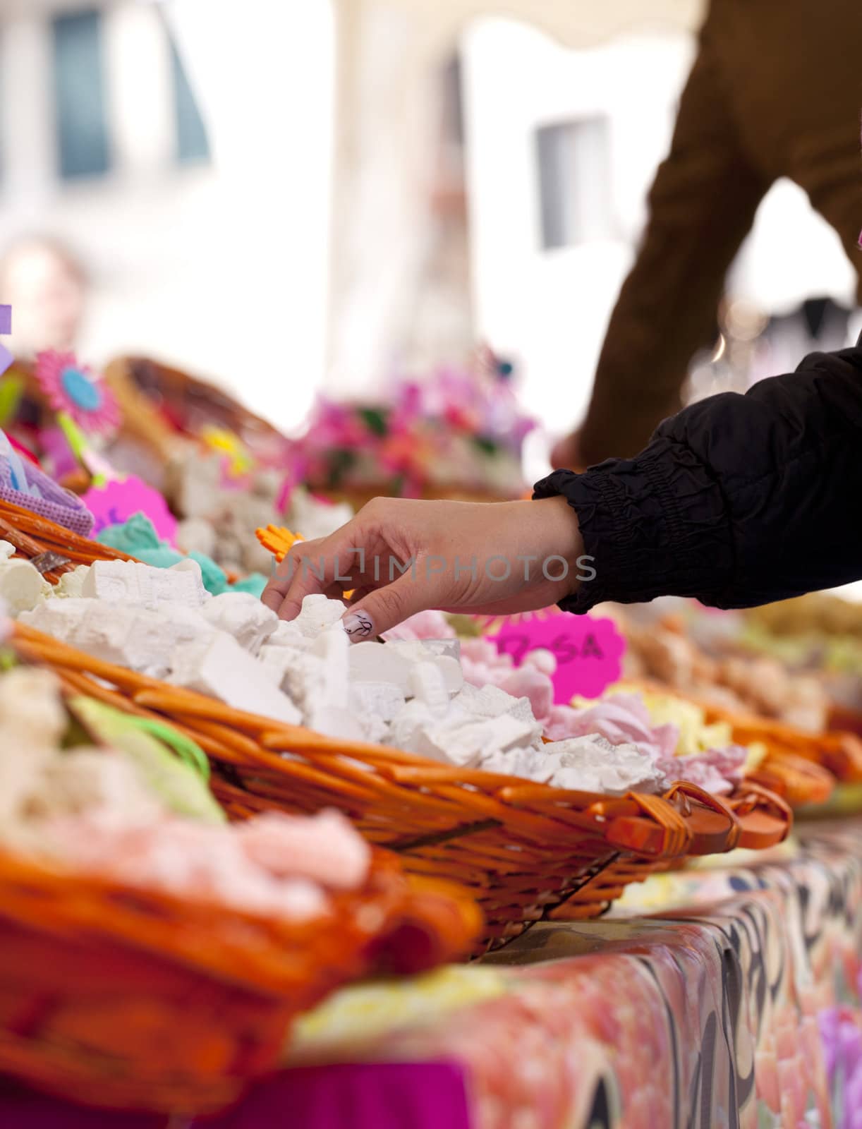 Woman take a soap inside a wicker bastket in the street market