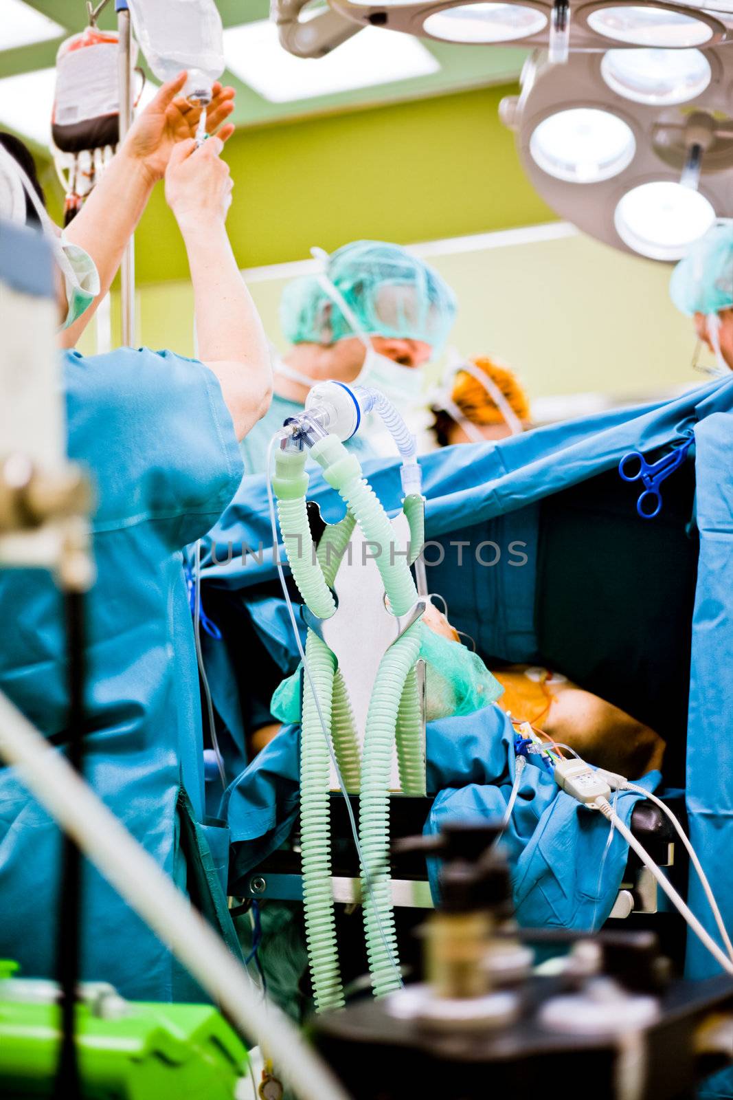 Patient under anesthesia with oxigen mask during surgery in operating room