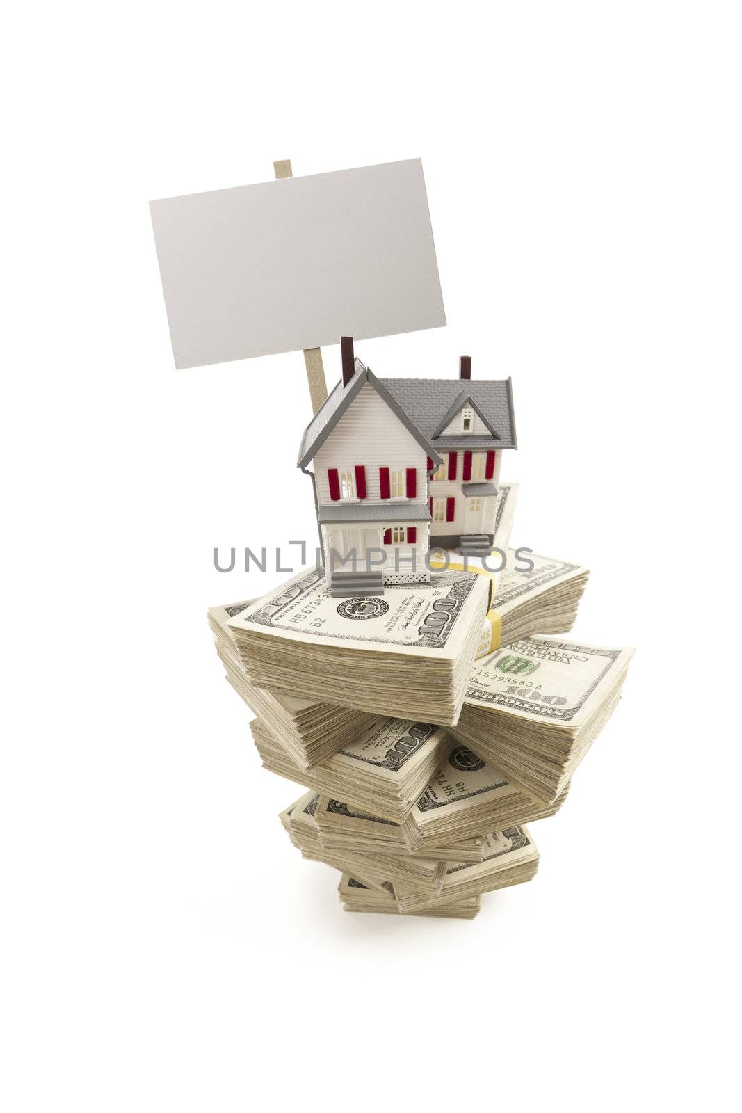 Small House on Stacks of Hundred Dollar Bills and Blank Sign Isolated on a White Background.