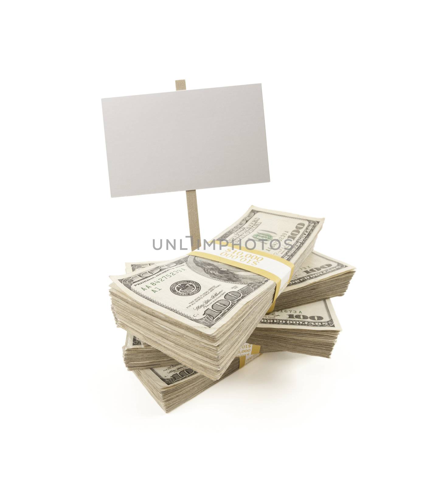 Stacks of One Hundred Dollar Bills with Blank Sign Isolated on a White Background.