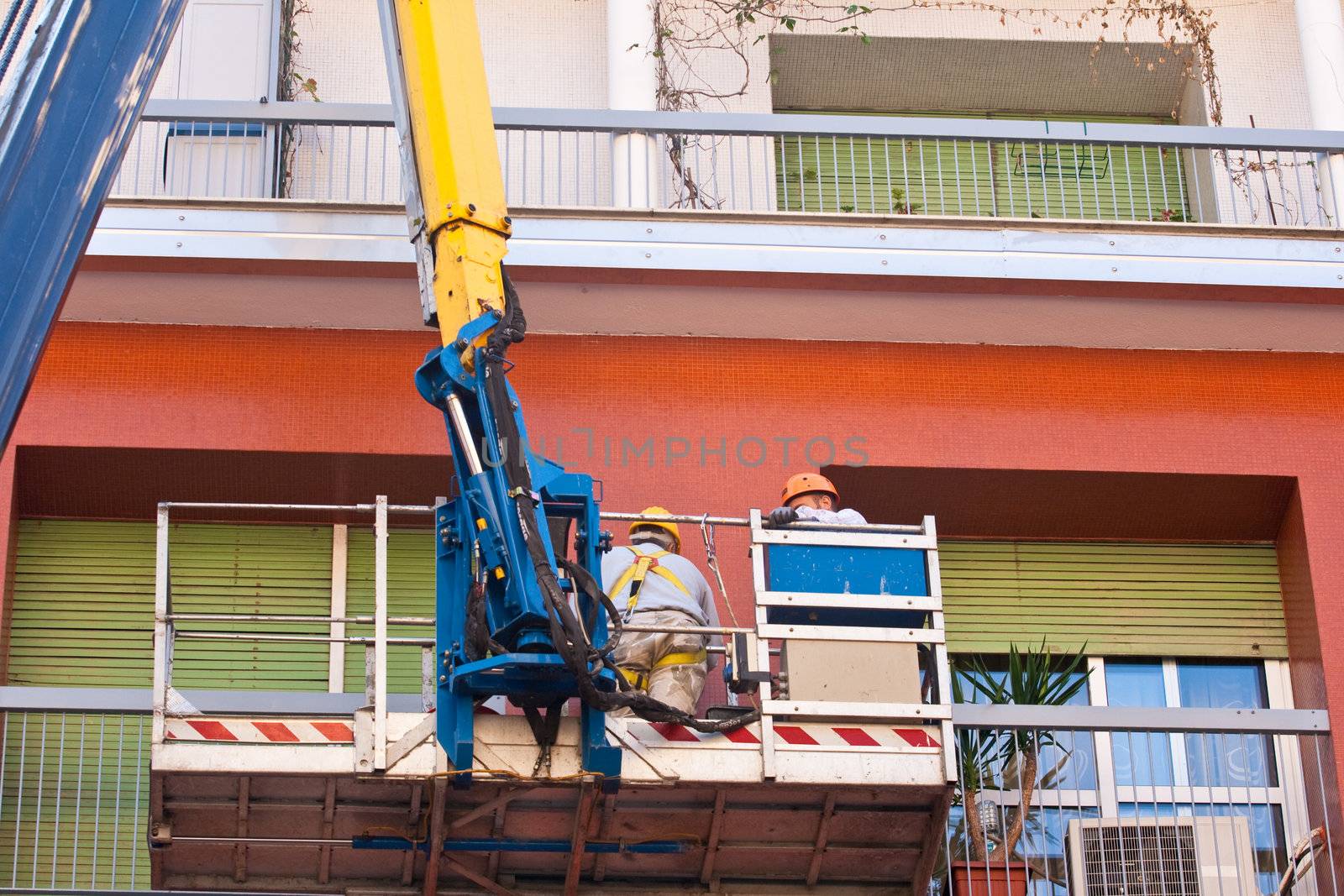Crane working in a red building
