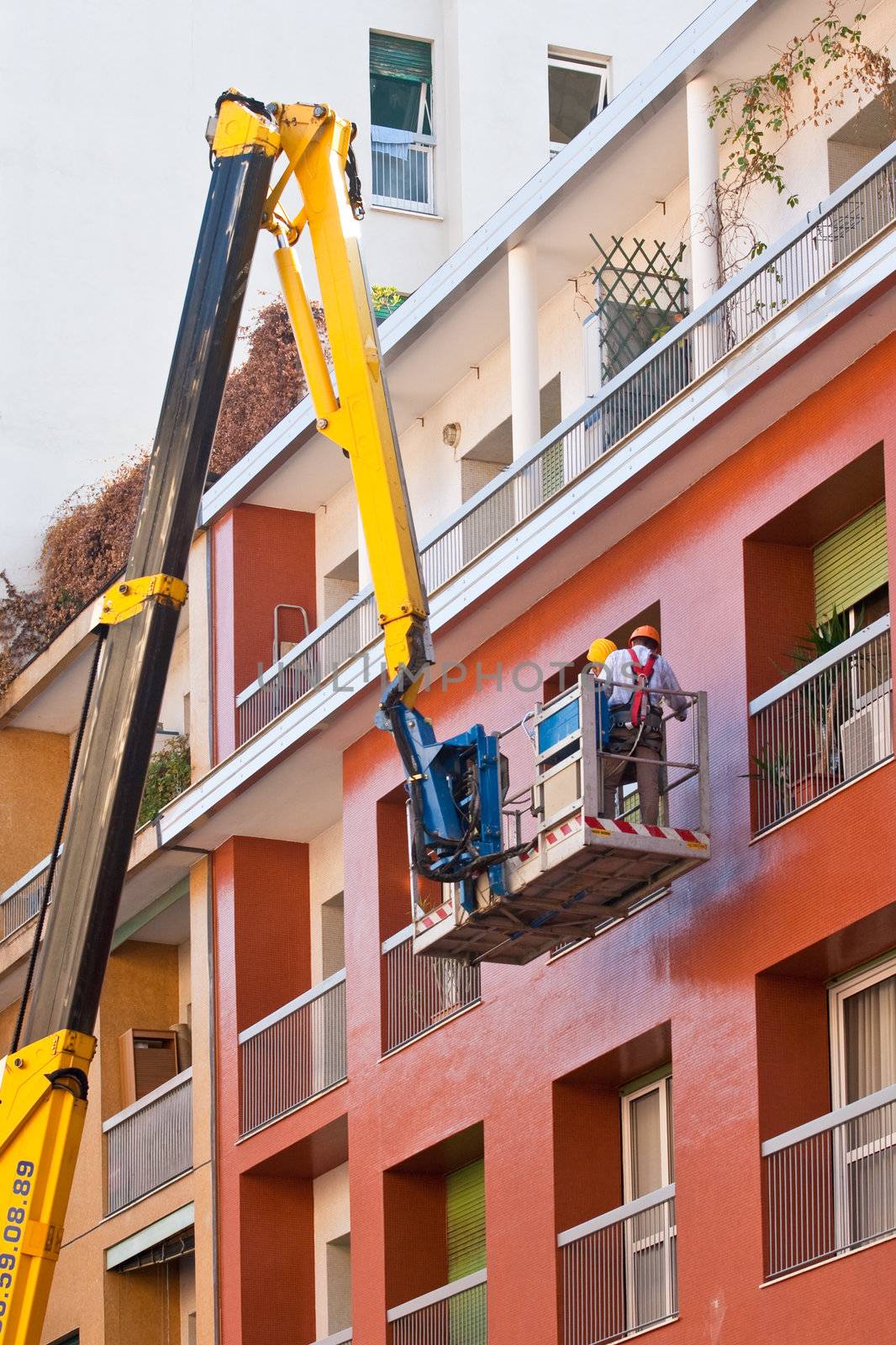 Crane working in a red building