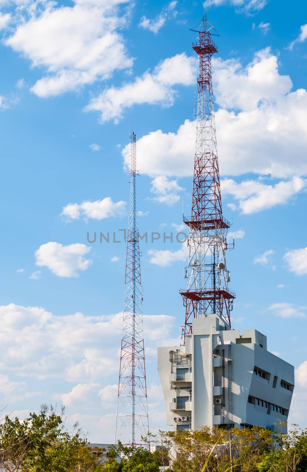 Telecommunication Antenna Tower on Building with blue sky and cloud by noneam