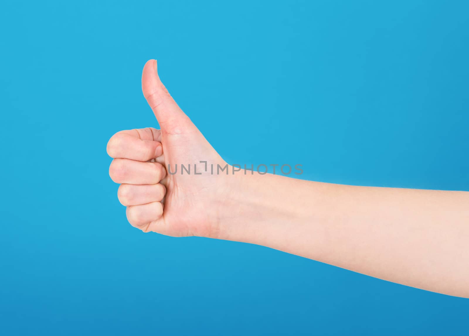 Right hand showing thumb up on blue background