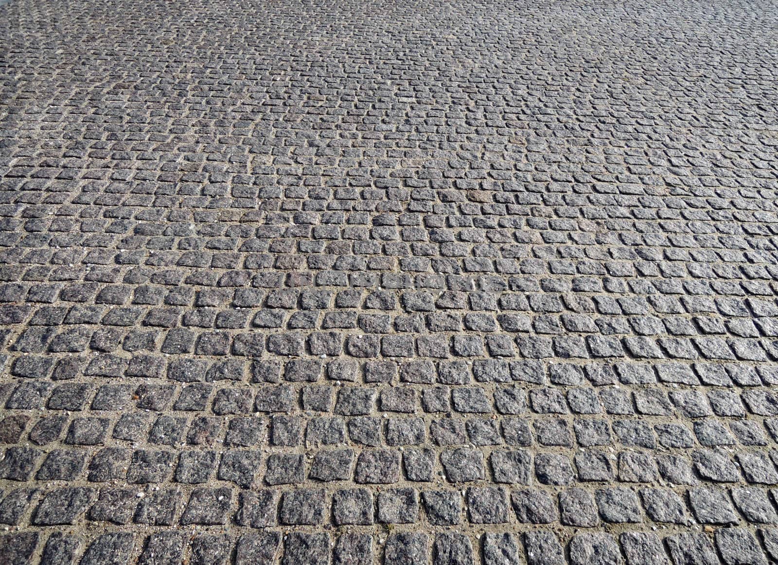 Closeup view on a cobblestone road - pattern - background