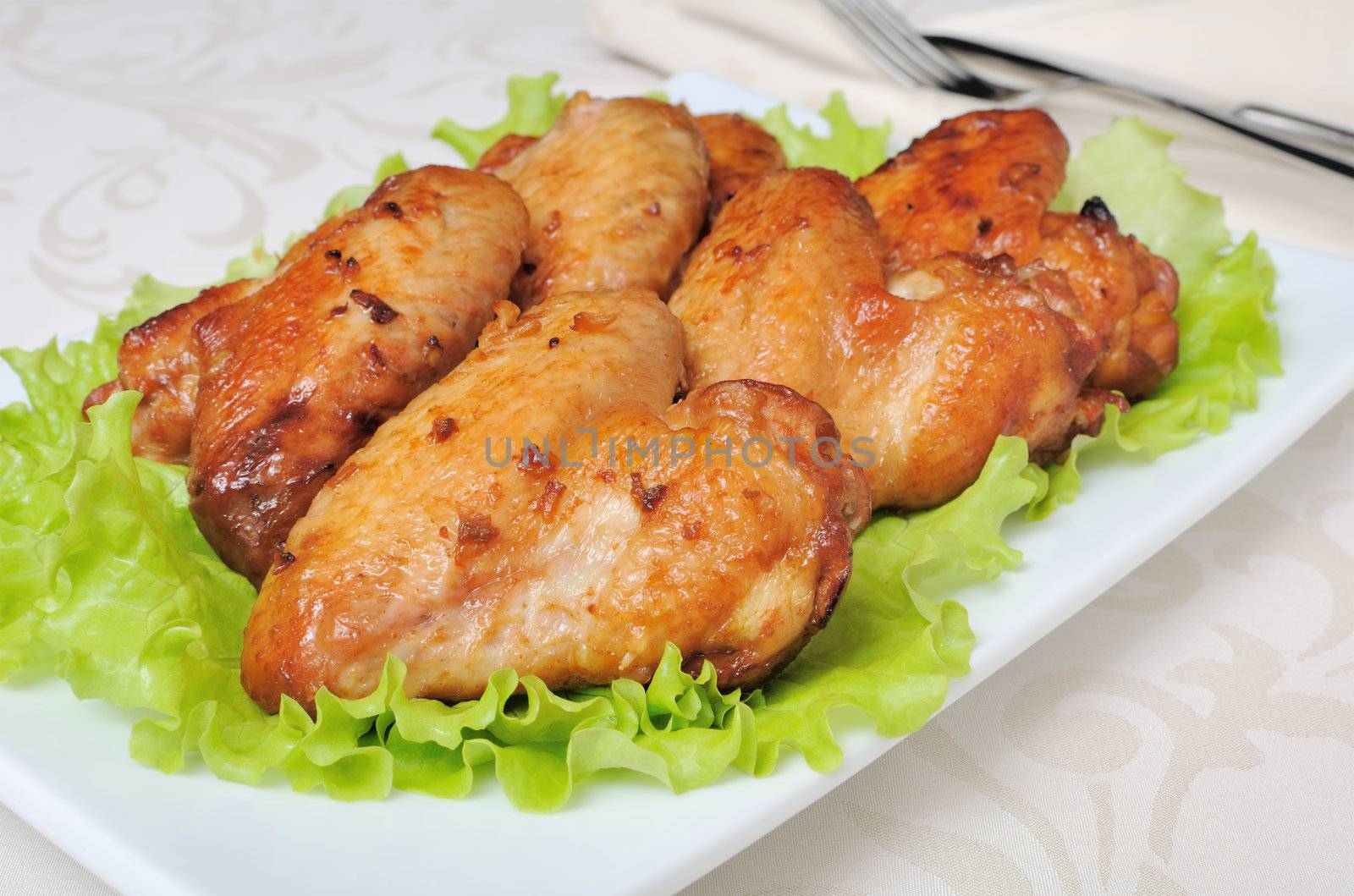 Baked chicken wings in honey and soy marinade with garlic