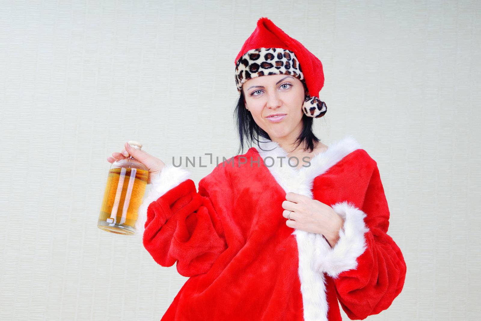 Drunken woman in Santa Claus costume with alcohol beverage