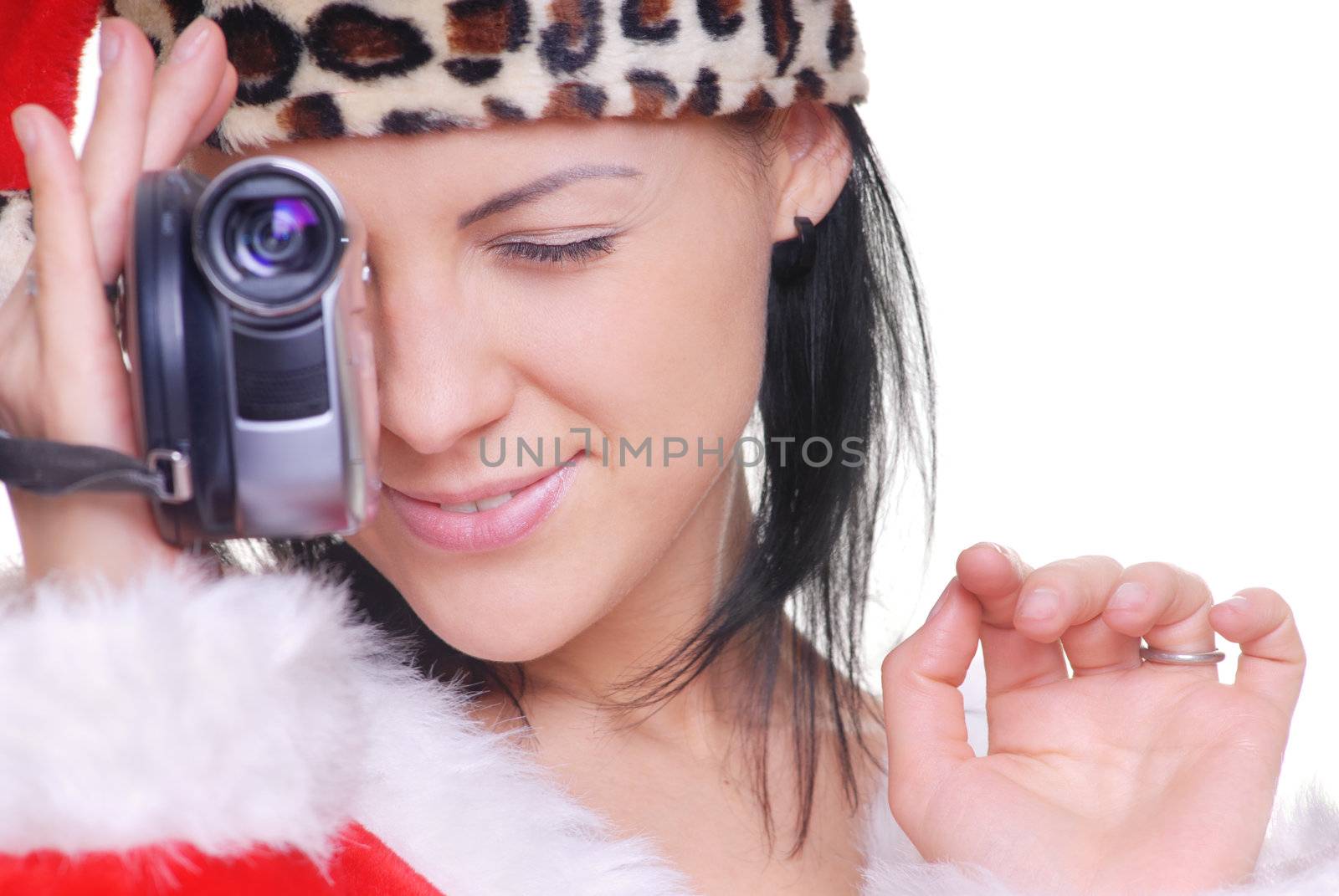 Attractive lady in Santa costume holding video camera
