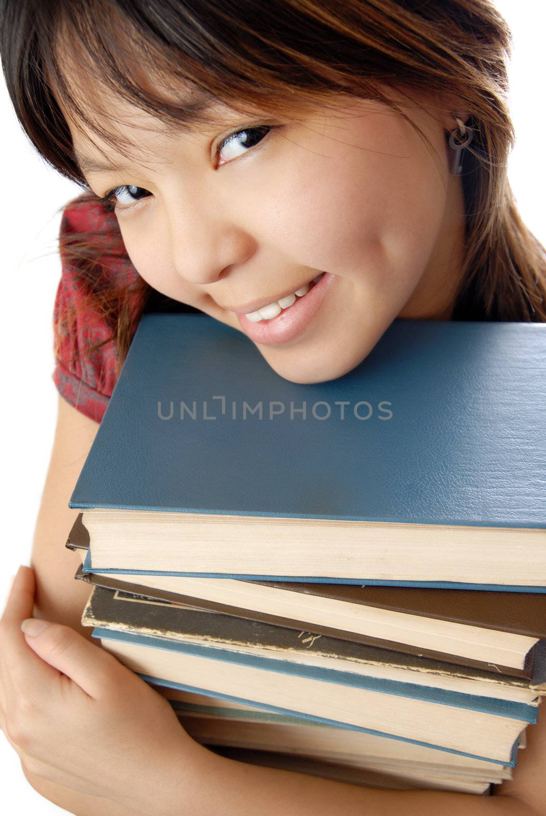 Young student with numerous books to be ready for exam