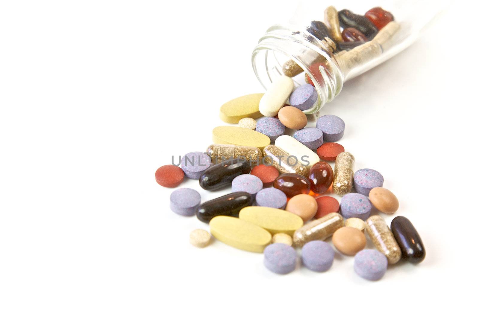 Pills and capsules in glass bottle