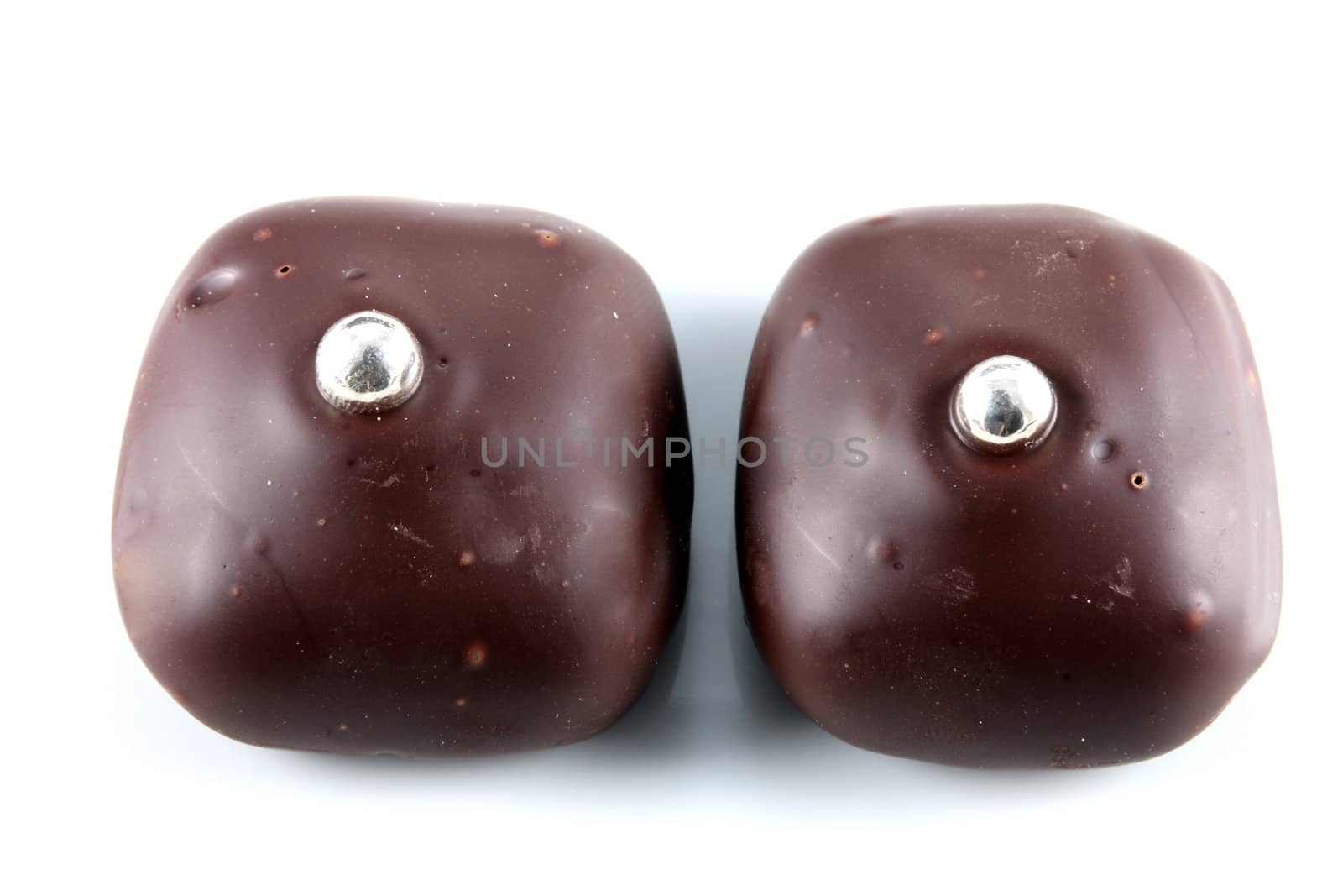 Two Black Chocolates With Decorative Beads Isolated On White Background