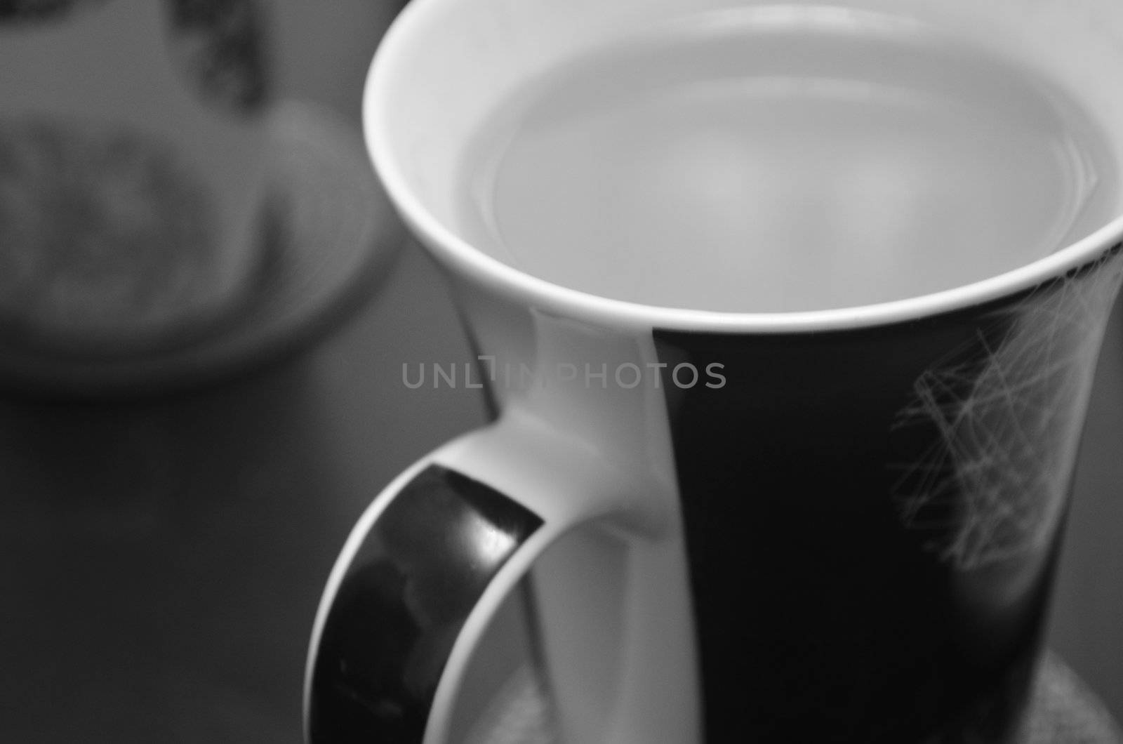 Monochrome close up of Mug containing hot beverage