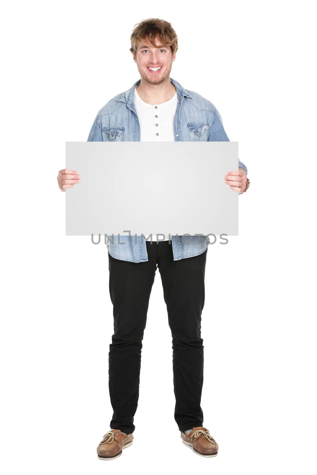 Man showing sign standing in full body. Casual young guy holding blank empty banner sign isolated on white background. Caucasian male model in his twenties.