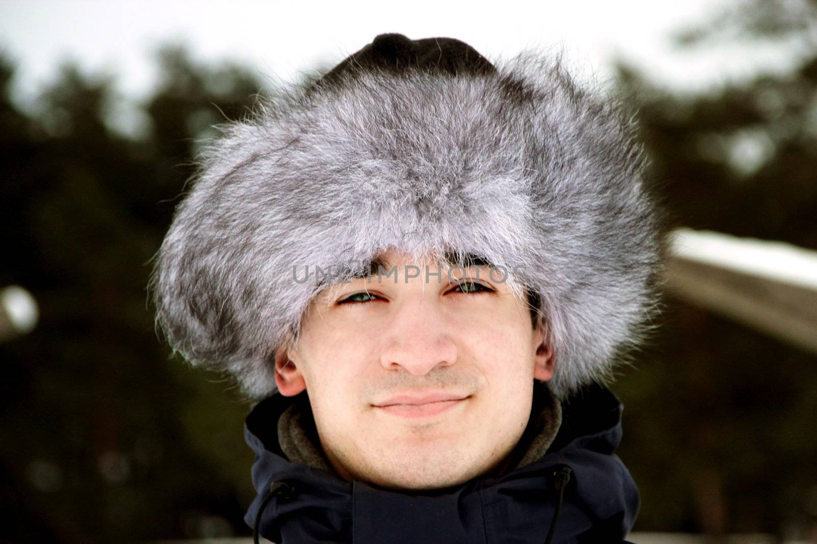 A portrait of man is in a fur cap