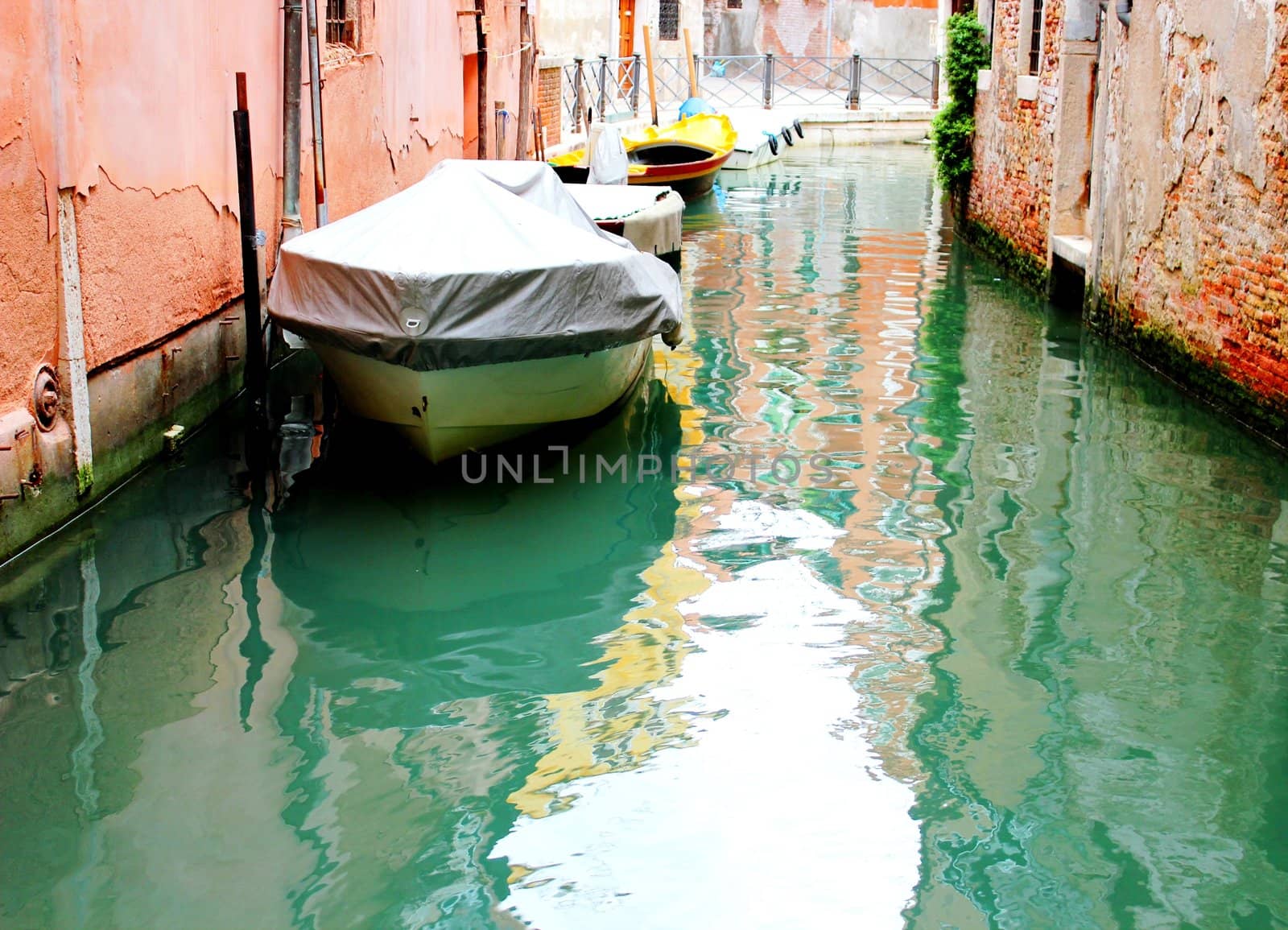 Canal of Venice with  bouts. blue water.